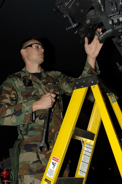 MINOT AIR FORCE BASE, N.D. -- Staff Sgt. Dustin Beacker, 5th Aircraft Maintenance Squadron weapons load crew member, performs a bomb rack preparation on a B-52H Stratofortress during a load crew competition here, Oct. 30.  Each load crew team consists of four Airmen who are evaluated every month on how well they load different types of weapons. (U.S. Air Force photo by Senior Airman Matthew Smith)