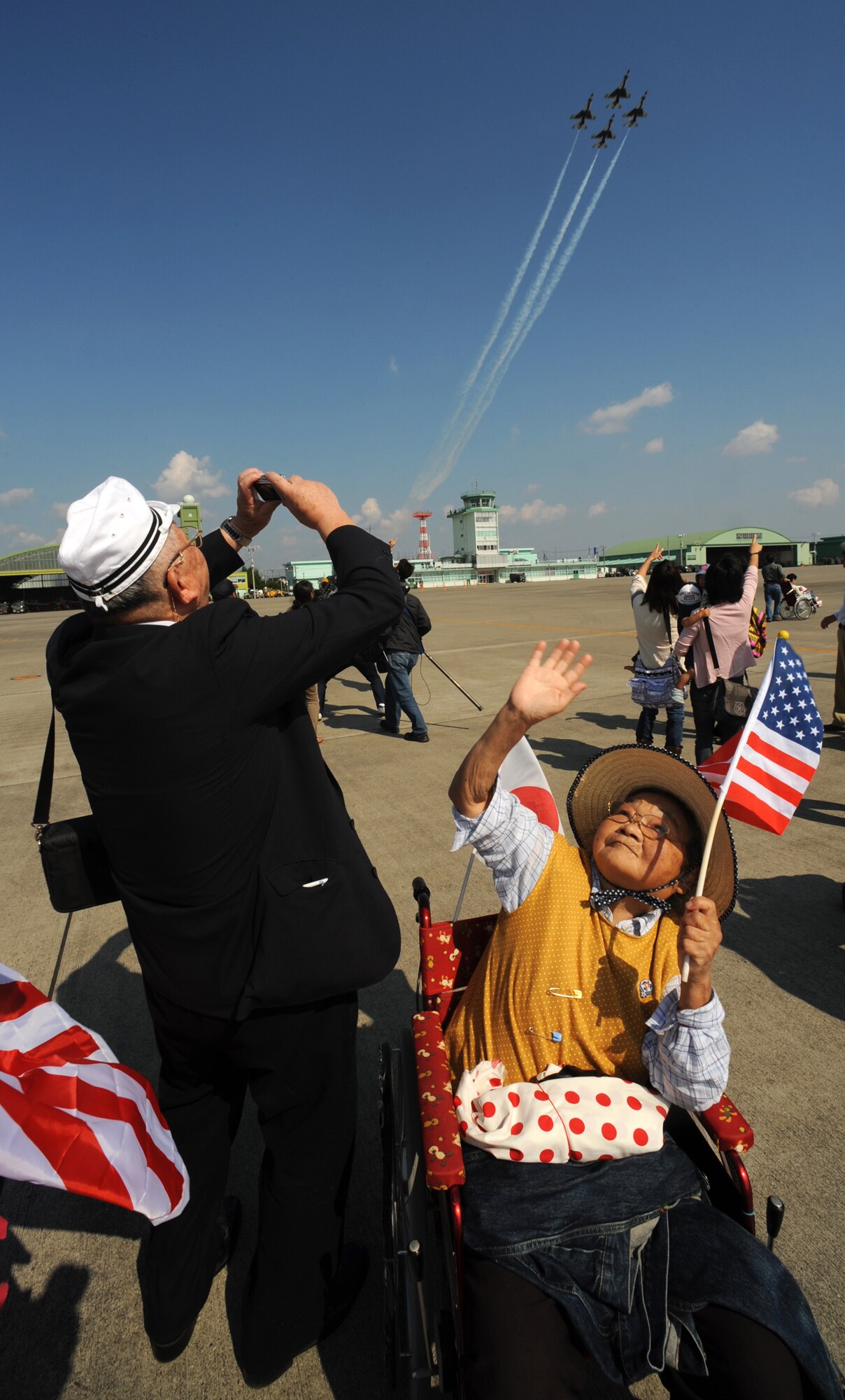 Citizens of Hamamatsu, Japan enjoy the day as the U.S. Air Force Thunderbirds practice overhead, Oct. 16, in preparation for the upcoming air show.  (U.S. Air Force photo by Staff Sgt. Kristi Machado)