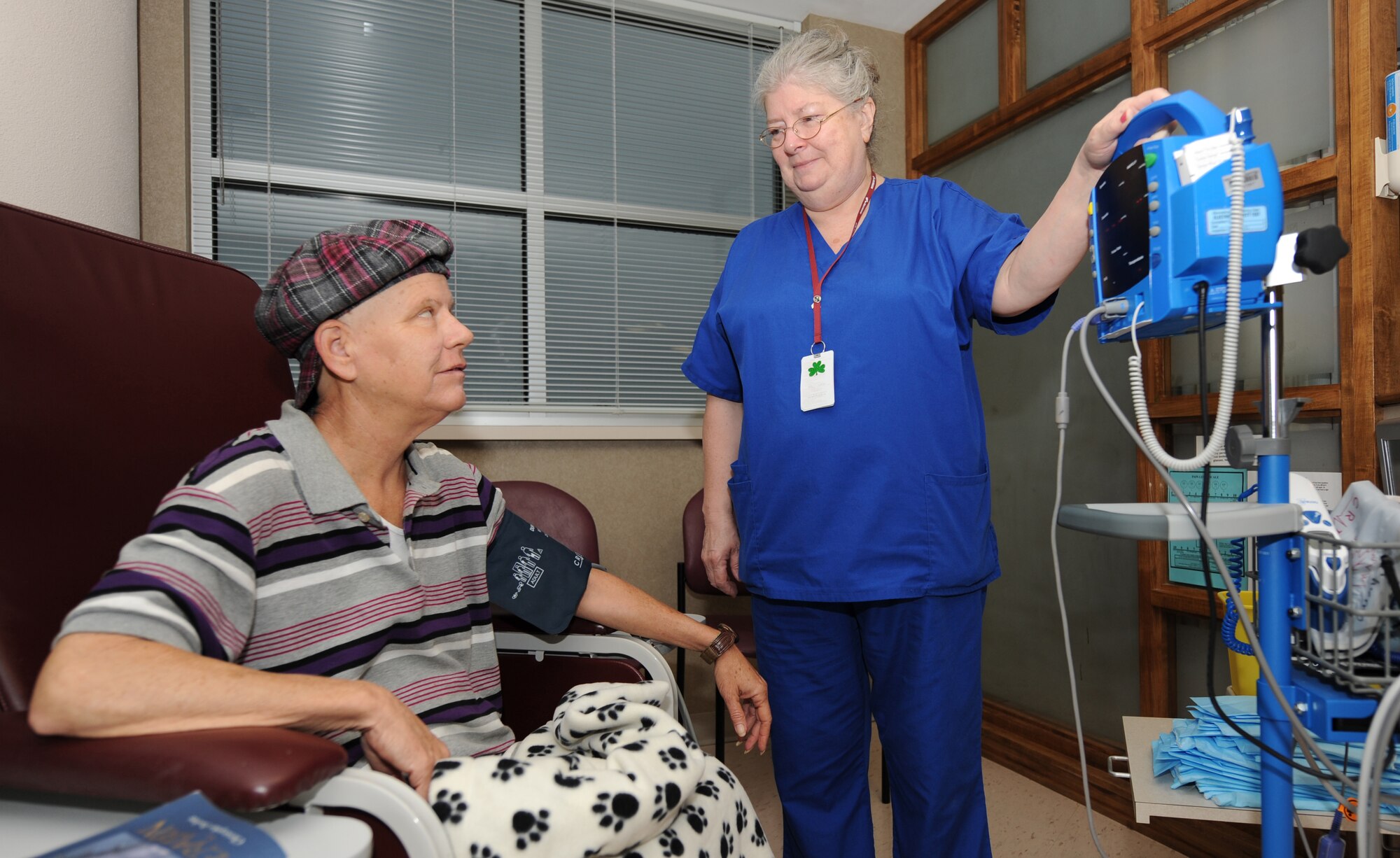Barksdale AFB, La. - Sally Jane Campbell, certified nurse assistant, checks Ms. Eveld’s vital signs before starting her chemotherapy treatment. This is her third treatment of six. (U.S. Air Force photo by Senior Airman Alexandra Longfellow) (RELEASED)