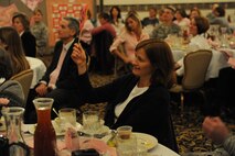 MINOT AIR FORCE BASE, N.D. -- Nelda Hoggan, wife of Col. Karlan Hoggan, 5th Medical Group commander, bids on a quilt being auctioned during the 4th annual Breast Cancer Awareness luncheon here Oct. 29. The luncheon featured guest speaker Dr. Edward Sauter, Associate Dean of research at Univesity of North Dakota school of medicine, and raised more than $3,500. (U.S. Air Force photo by Senior Airman Sharida Jackson).