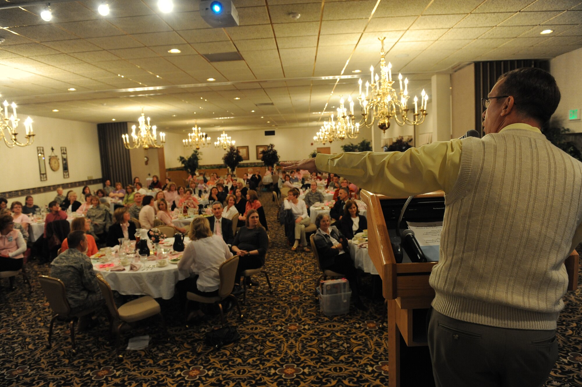 MINOT AIR FORCE BASE, N.D. --  Bill Large, 5th Medical Group readiness officer, auctioned off a quilt during the 4th annual Breast Cancer Awareness luncheon here Oct. 29. The lucheon, which had 125 attendees, featured a guest speaker and raised more than $3,500.  (U.S. Air Force photo by Senior Airman Sharida Jackson).