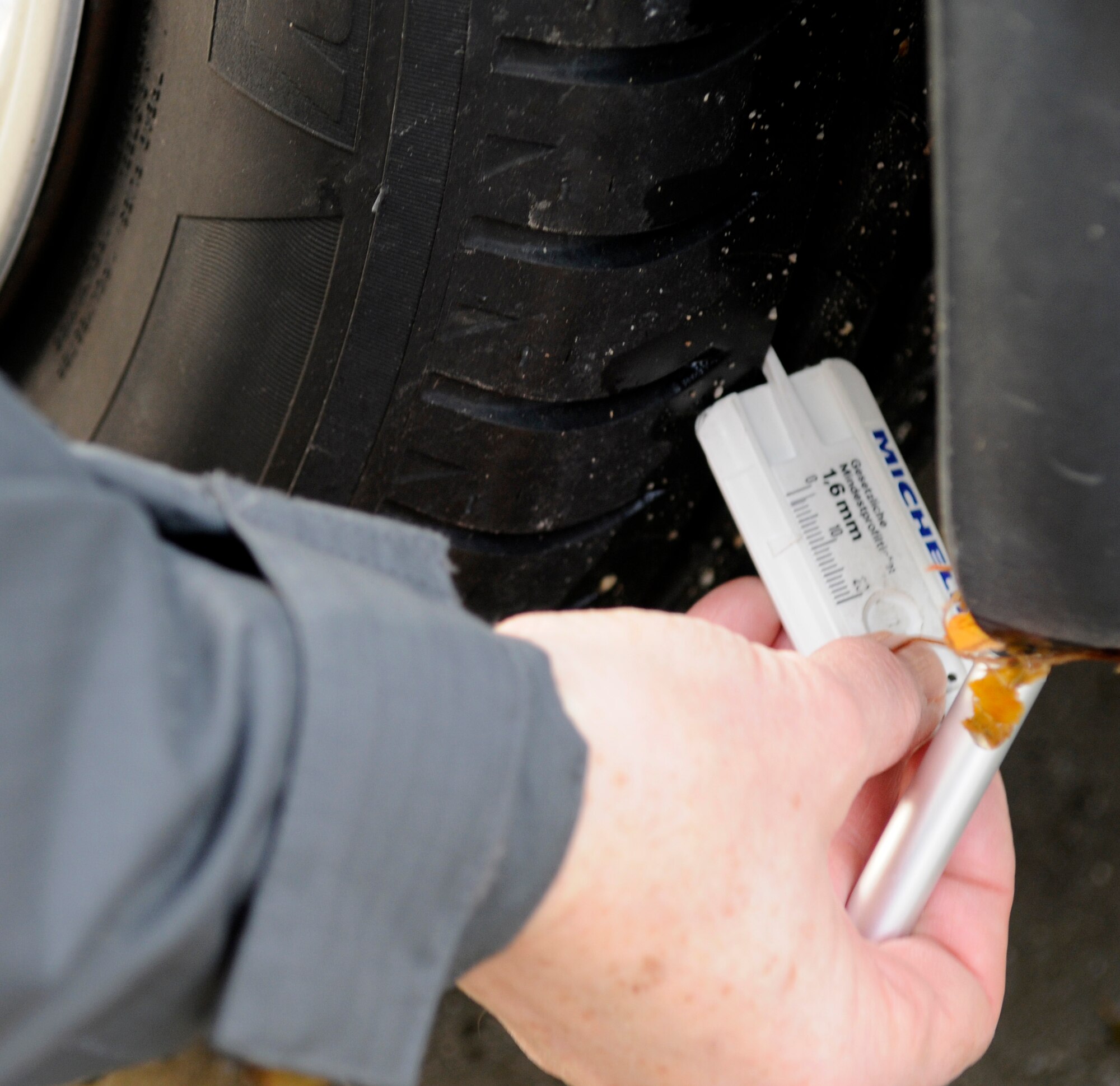SPANGDAHLEM AIR BASE, Germany – Wolfgang Gaida, ADAC representative, checks a vehicle’s tire tread during a free winter vehicle check held at the Saber Driving Course Nov. 2.  The 52nd Fighter Wing Safety Office and ADAC representatives checked tires, brake fluid, lights, batteries, antifreeze conditions and performed child safety seat checks. There will be another free vehicle inspection Nov. 15. (U.S. Air Force photo/Airman 1st Class Staci Miller)