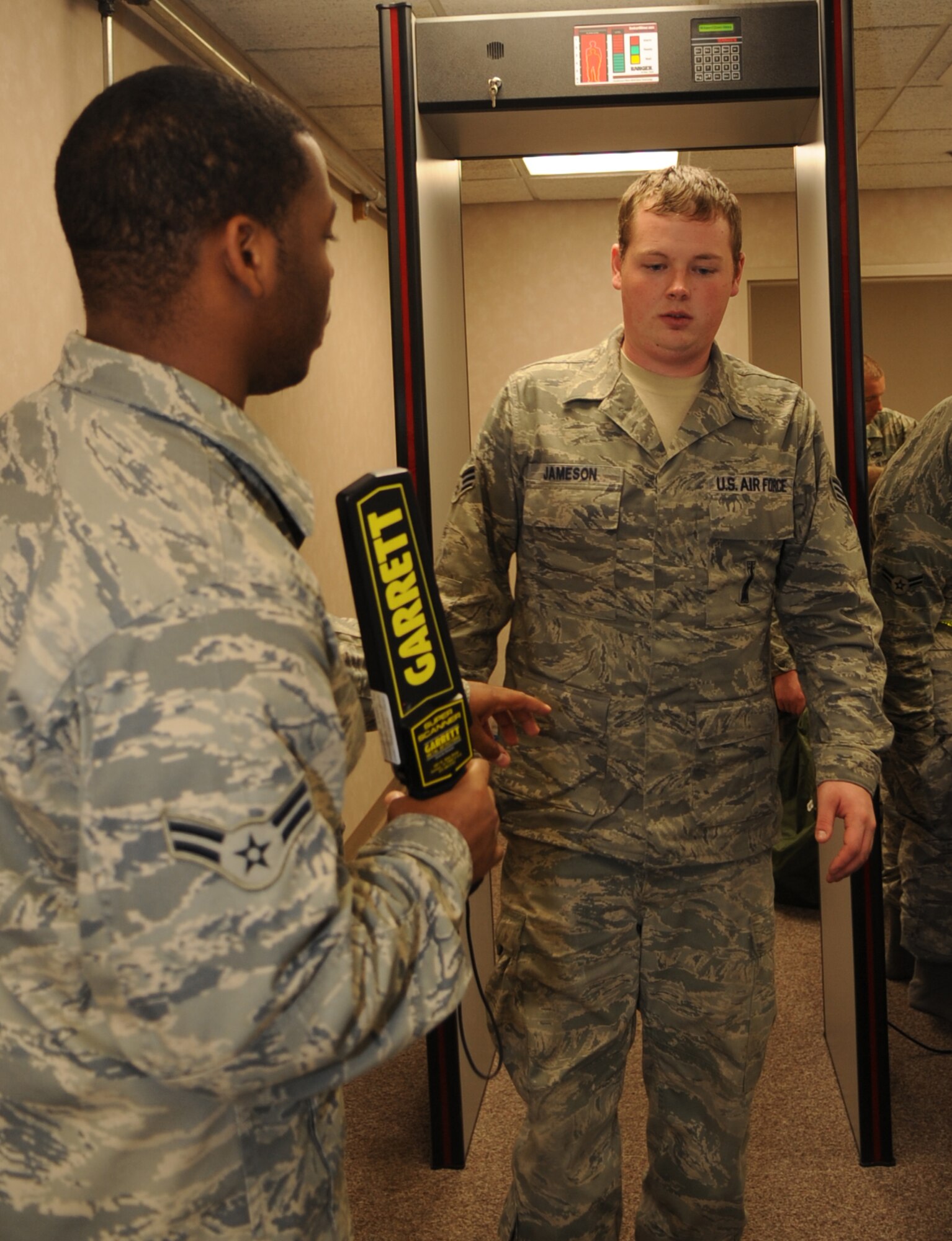 Senior Airman Joshua Jameson, 2d Aircraft Maintenance Squadron, walks through security after processing through the PDF line at Hoban Hall Oct. 26. (U.S. Air Force photo by Senior Airman Alexandra Longfellow)(RELEASED)