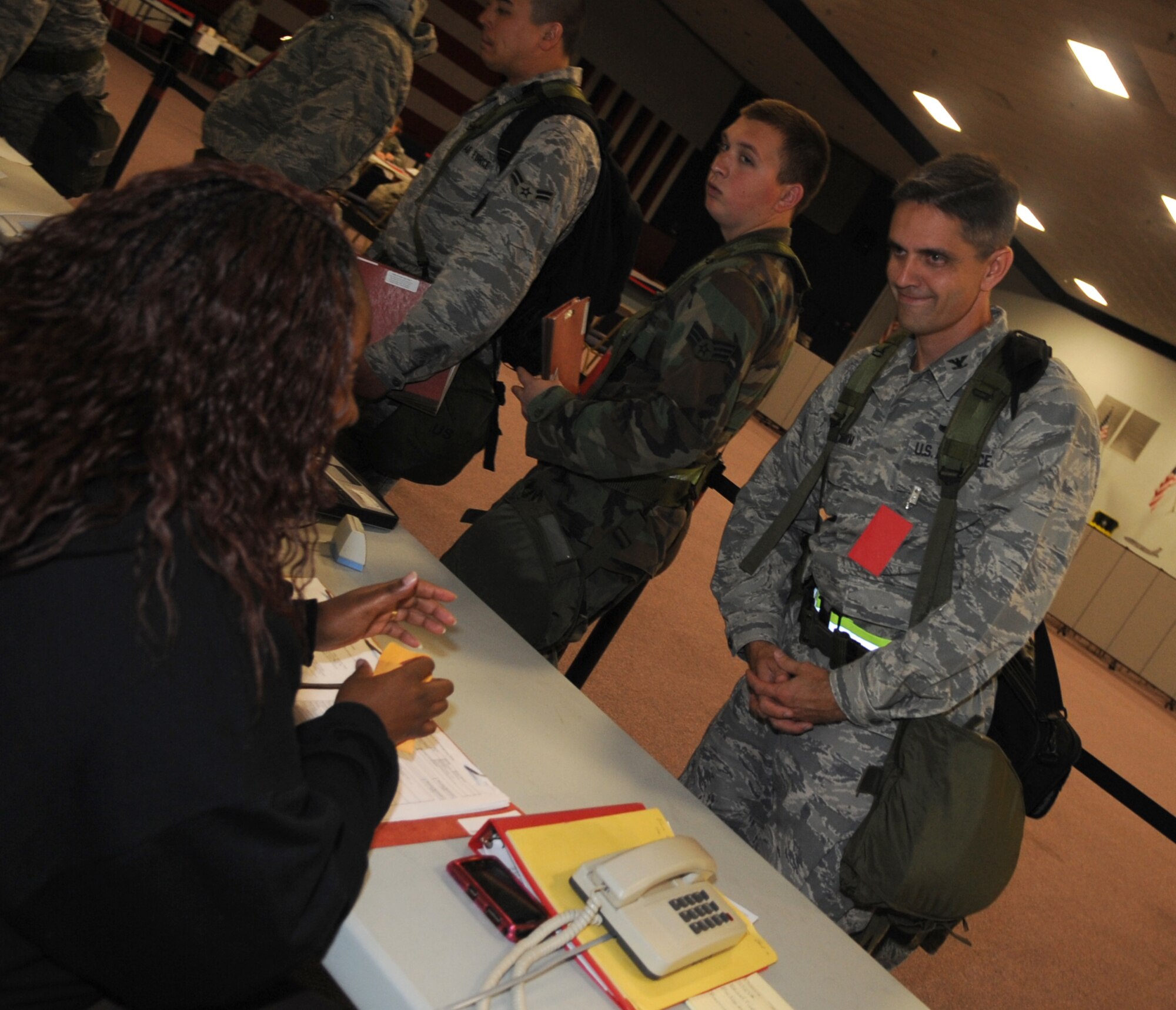 Barksdale AFB, La. - Col. Steven Basham, 2d Bomb Wing commander, processes through the pre-deployment line as part of the Base X contingency deployment during Exercise Global Cajun conventional operational readiness exercise. (U.S. Air Force photo by Senior Airman Alexandra Longfellow)(RELEASED)