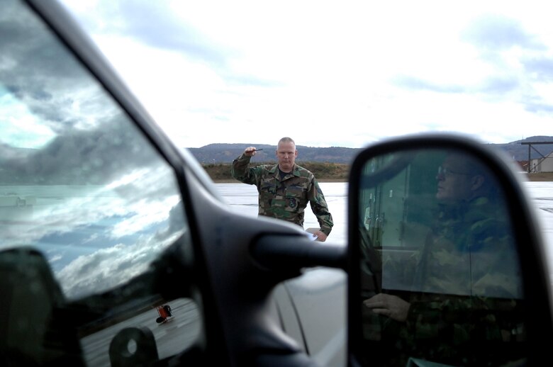 Staff Sgt. Edward Cunningham uses hand-signals to tell Tech. Sgt. Michael Voltmer which turn-signal to use during a vehicle checkout, Nov. 4, 2009, Ramstein Air Base, Germany. Sergeants Cunningham and Voltmer are traditional reservist serving a deployment here with the 38th Expeditionary Airlift Squadron. (U.S. Air Force photo by Tech. Sgt. Michael Voss)