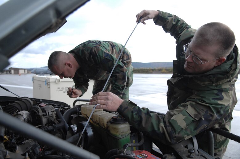 Staff Sgt. Edward Cunningham (far) Tech. Sgt. Michael Voltmer perform a vehicle checkout, Nov. 4, 2009, Ramstein Air Base, Germany. Sergeants Cunningham and Voltmer are traditional reservist serving a deployment here with the 38th Expeditionary Airlift Squadron. (U.S. Air Force photo by Tech. Sgt. Michael Voss)