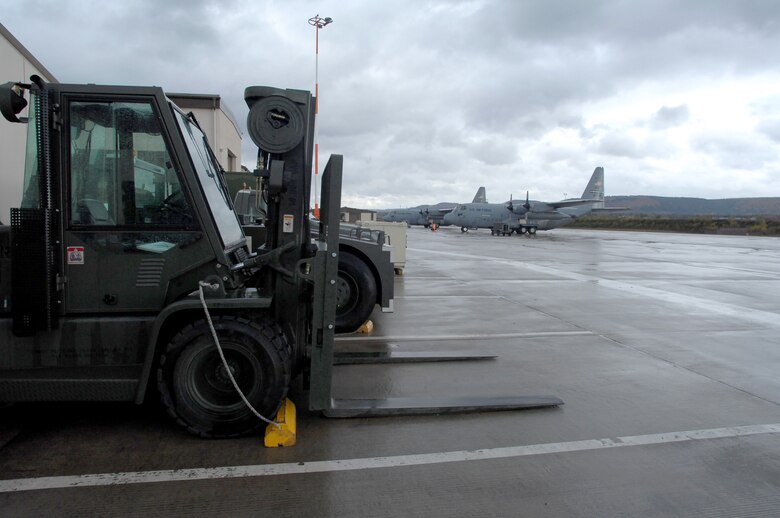 Two 38th Expeditionary Airlift Squadron C-130s stand waiting on flightline Nov. 4, 2009, Ramstein Air Base, Germany. The 38th EAS mission is different from other units here because the unit is faced with almost constant personnel turnover, as most of their personnel are traditional reservists serving no longer than six months at a time. (U.S. Air Force photo by Tech. Sgt. Michael Voss)