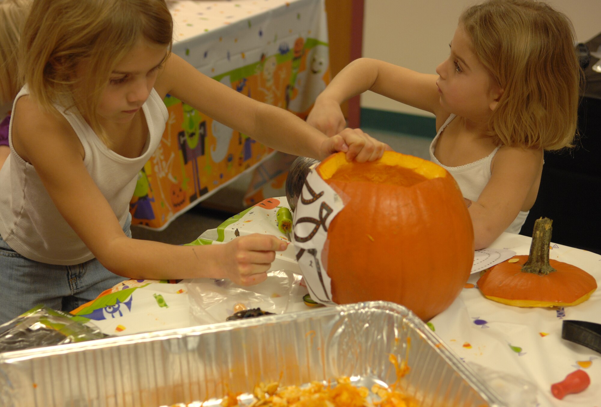 Madisyn and Elizabeth Peterson, daughters of Staff Sgt. Matthew Peterson, 354th Logistics Readiness Squadron, carve pumpkins during a class at the Airman and Family Readiness Center Oct. 30, 2009, Eielson Air Force Base, Alaska. The pumpkin carving class is one of the many different classes the Airman and Family Readiness Center offers for Airmen and their families. (U.S. Air Force photo/Airman 1st Class Rachelle Coleman)
