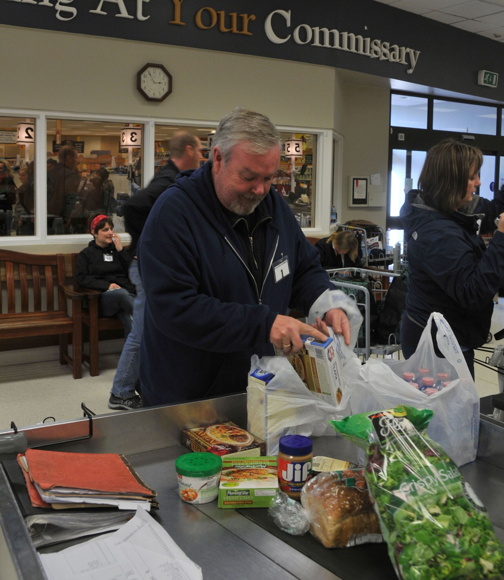 Owen Heneghan, RAF Lakenheath Commissary head bagger, bags groceries at RAF Lakenheath, England Nov. 3. Mr. Heneghan has been working at the commissary since April, 1995. The baggers are a multi-talented, diverse group, but they share one purpose: to make sure customers are happy when they leave the commissary.  (U.S. Air Force photo by Airman 1st Class Eboni Knox)