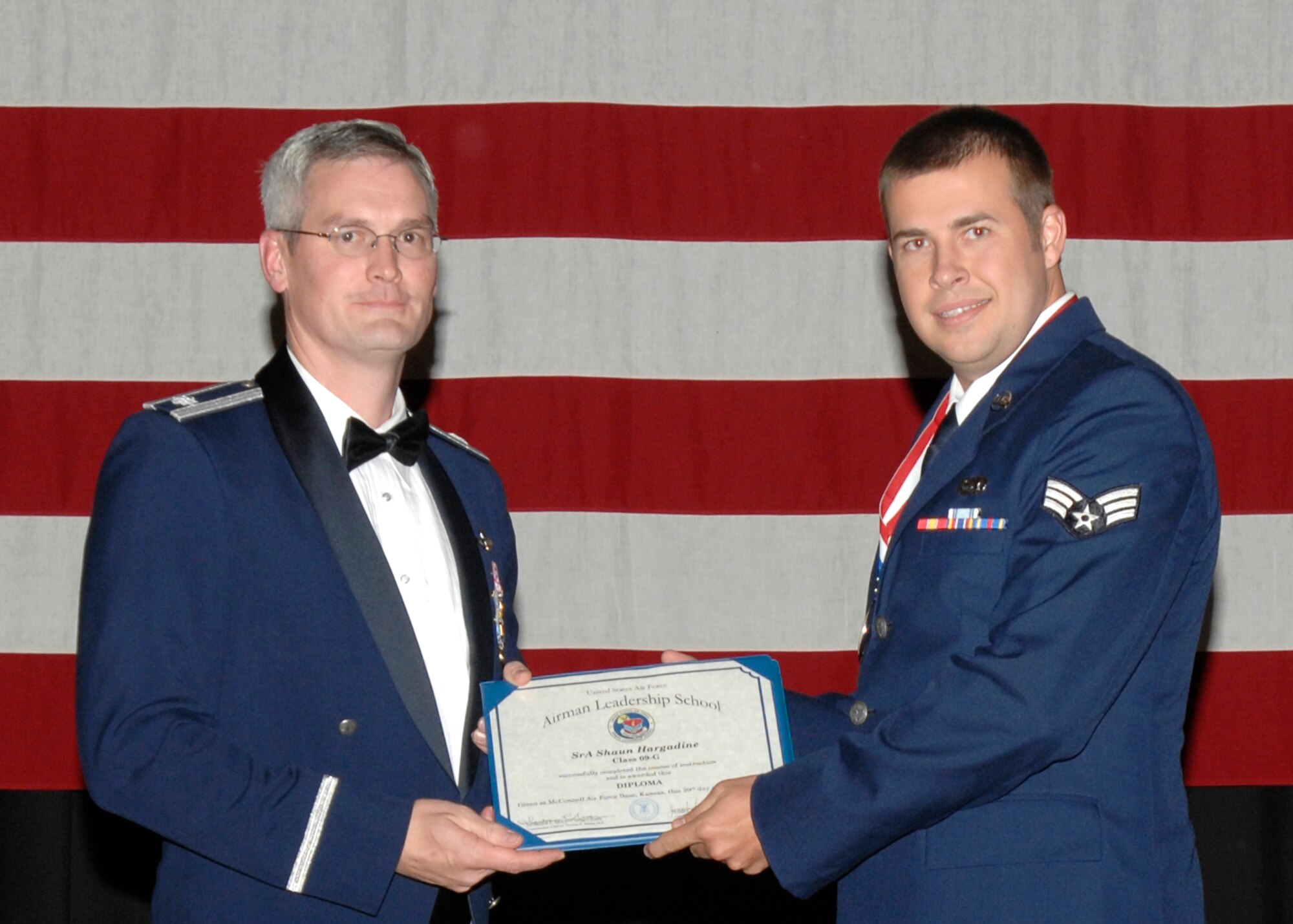 Senior Airman Shaun Hargadine received an Academic Achievement Award during an Airman Leadership School graduation ceremony at McConnell Air Force Base, Kan., on Oct. 29. Airman Hargadine is a Reservist assigned to the 931st Aircraft Maintenance Squadron, an unit within 931st Air Refueling Group. Also pictured (on left) is Lt. Col. Randall Sauer, acting 931st ARG vice commander. (U.S. Air Force photo/Senior Airman Laura Suttles)
