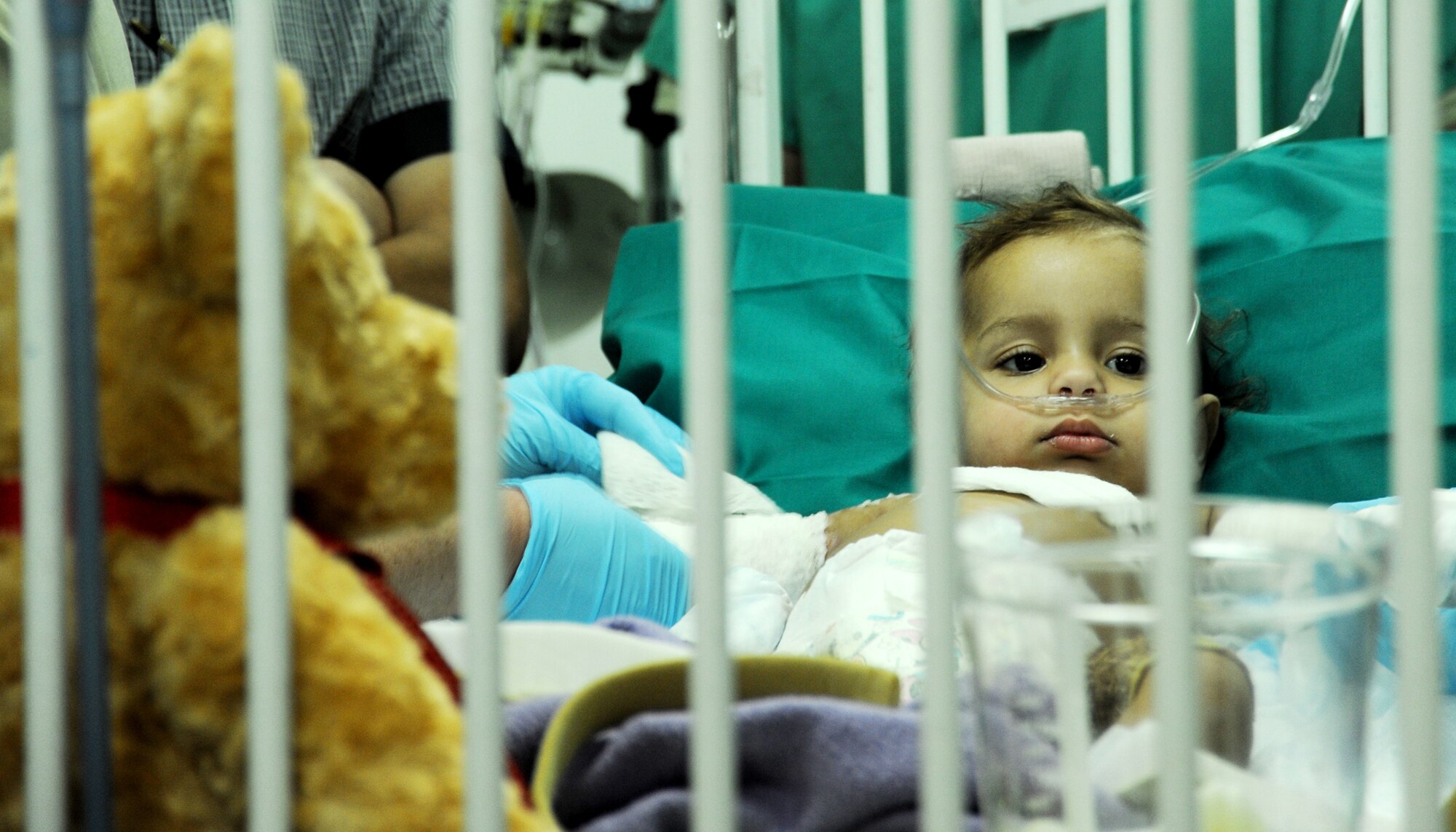 JOINT BASE BALAD, Iraq – An Iraqi child recovering from third degree burns lies in a crib at the Air Force Theater Hospital Oct. 30, 2009. Airmen of the 332nd Expeditionary Medical Operations Squadron provided treatment for her injuries, suffered in a household accident. (U.S. Air Force photo/Senior Airman Christopher Hubenthal)