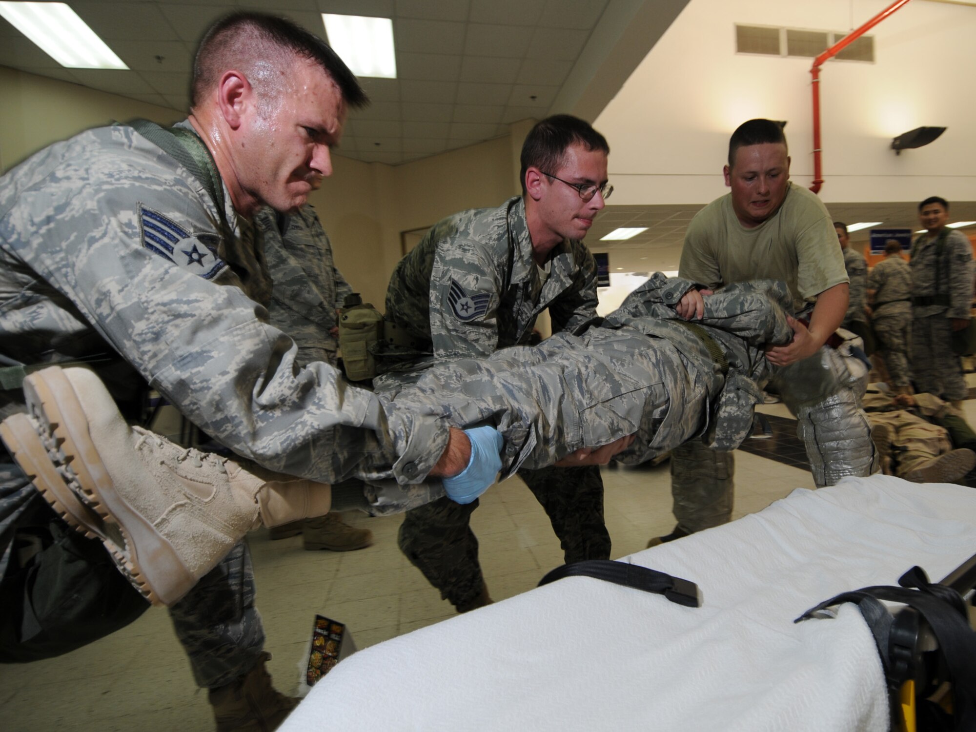 Deployed servicemembers transport a simulated casualty during a basewide exercise at an undisclosed location in Southwest Asia, Nov. 3, 2009. Personnel assigned to the 379th Air Expeditionary Wing and other tenant units participate in exercises regularly to train on a variety of potential real-world scenarios. (U.S. Air Force Photo/Tech. Sgt. Jason W. Edwards)