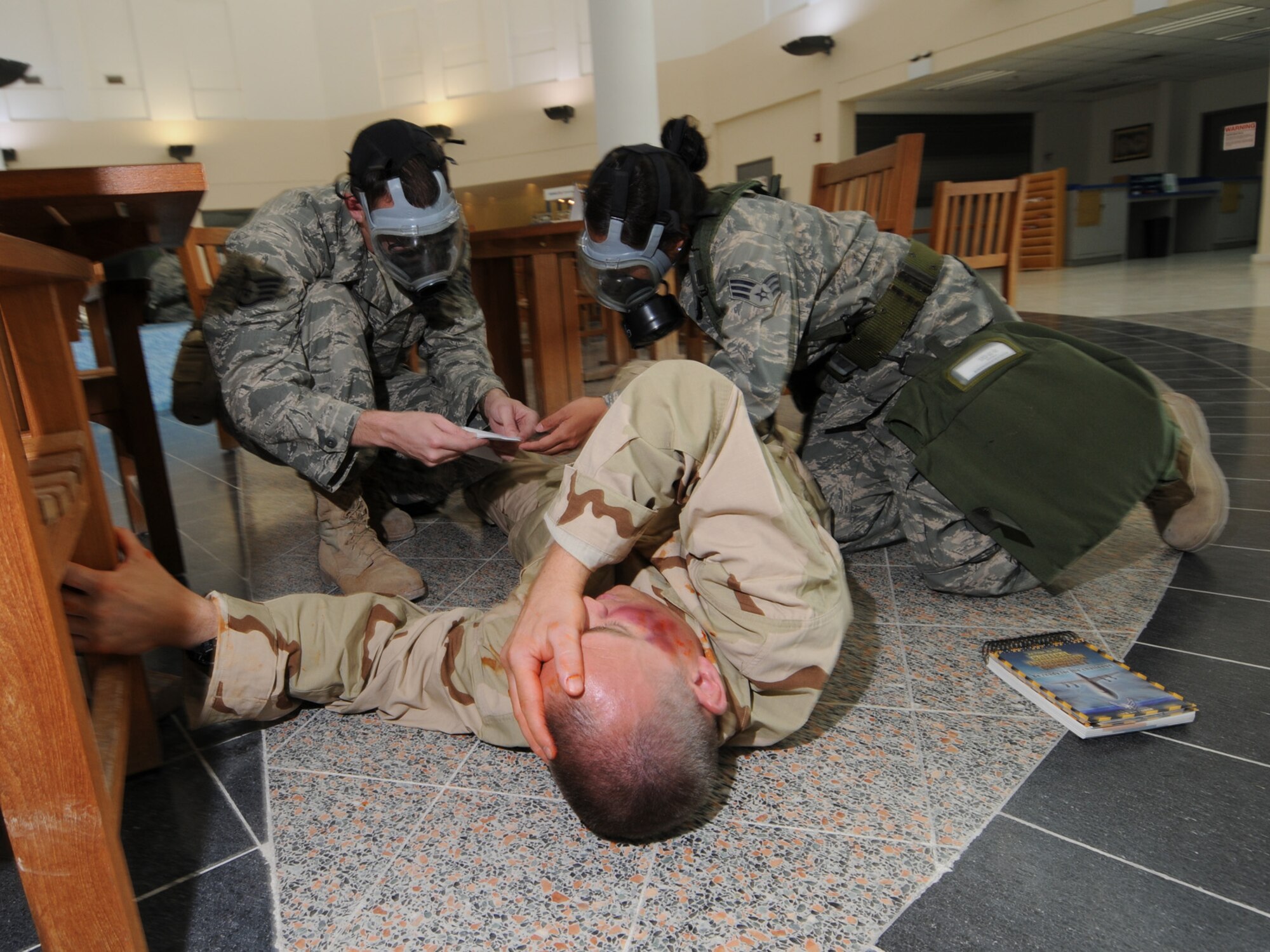 Deployed servicemembers treat a simulated casualty during a basewide exercise at an undisclosed location in Southwest Asia, Nov. 3, 2009. Personnel assigned to the 379th Air Expeditionary Wing and other tenant units participate in exercises regularly to train on a variety of potential real-world scenarios. (U.S. Air Force Photo/Tech. Sgt. Jason W. Edwards)