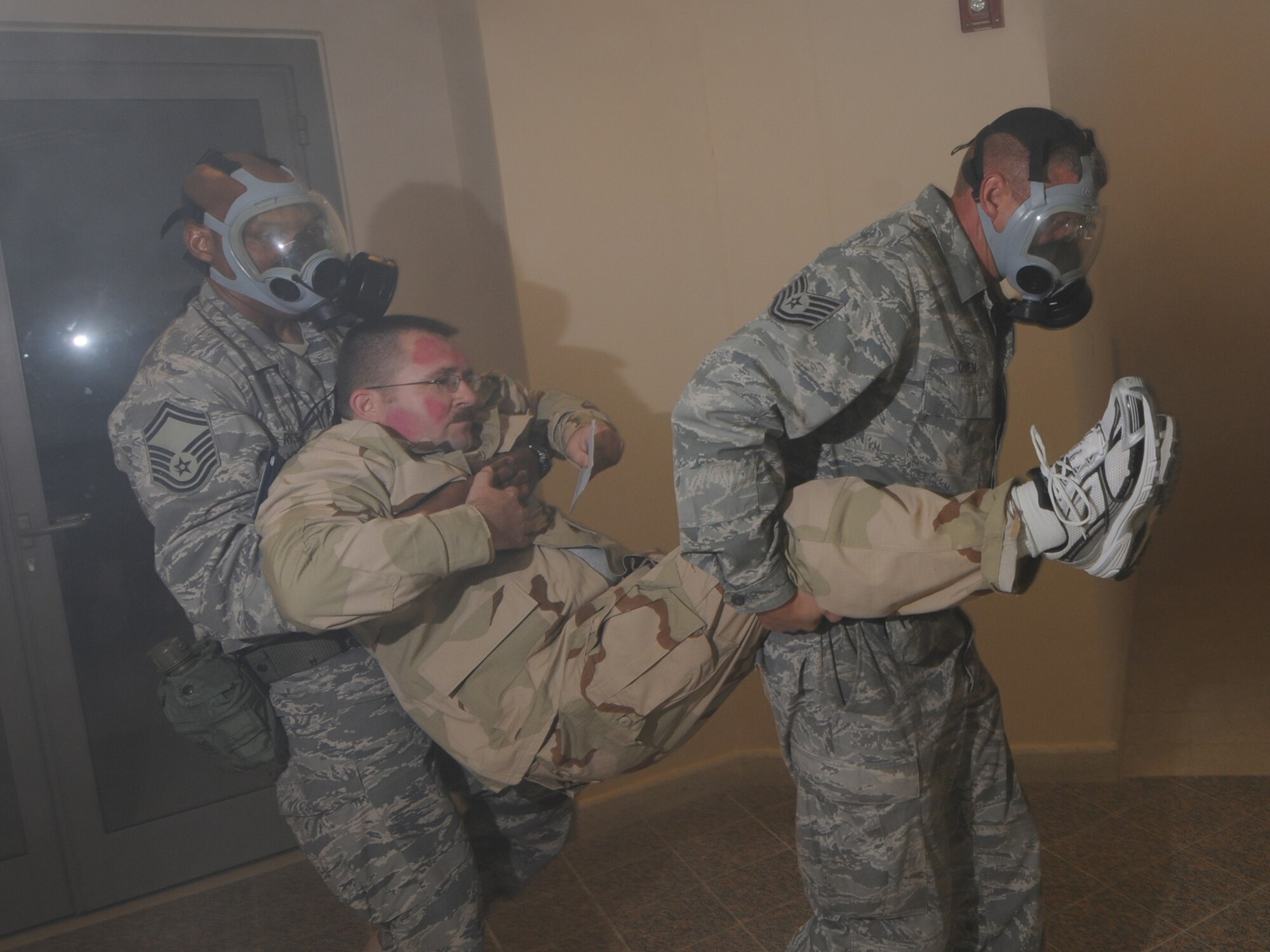 Deployed servicemembers transport a simulated casualty during a basewide exercise at an undisclosed location in Southwest Asia, Nov. 3, 2009. Personnel assigned to the 379th Air Expeditionary Wing and other tenant units participate in exercises regularly to train on a variety of potential real-world scenarios. (U.S. Air Force Photo/Tech. Sgt. Jason W. Edwards)