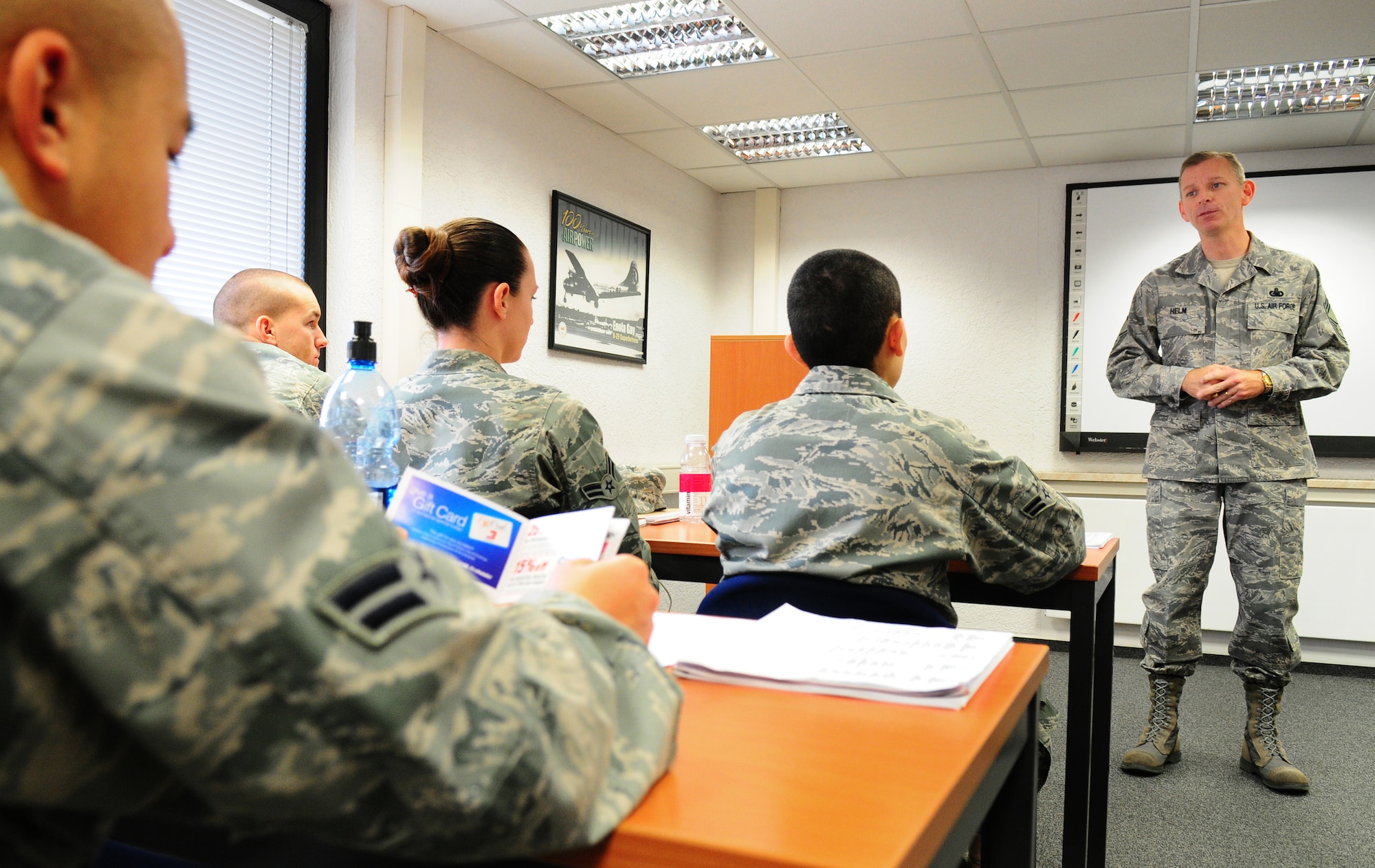 U.S. Air Force Chief Master Sgt. Jeffry D. Helm, the Senior Enlisted leader to the Commanding General, Army and Air Force Exchange Service (AAFES) visits with Airmen at Ramstein Air Base, First Term Airmen's Center.  Helm's focus was to inform Airmen, new to the Air Force what AAFES role was in providing services to them and their families.   (U.S. Air Force Photo by Staff Sgt. Jocelyn Rich) 