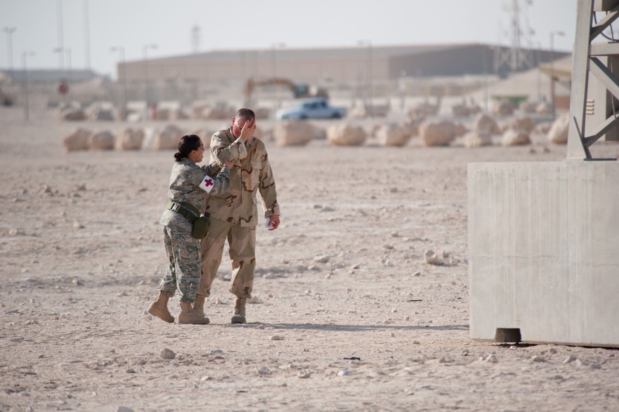 Senior Airman Cassondra Johnson, 379th Expeditionary Medical Group medical technician, helps a simulated casualty during a base defense exercise, Nov. 3, 2009 in Southwest Asia. Personnel assigned to the 379th Air Expeditionary Wing and other tenant units participate in exercises regularly to train on a variety of potential real-world scenarios. (U.S. Air Force Photo/Staff Sgt. Robert Barney) 