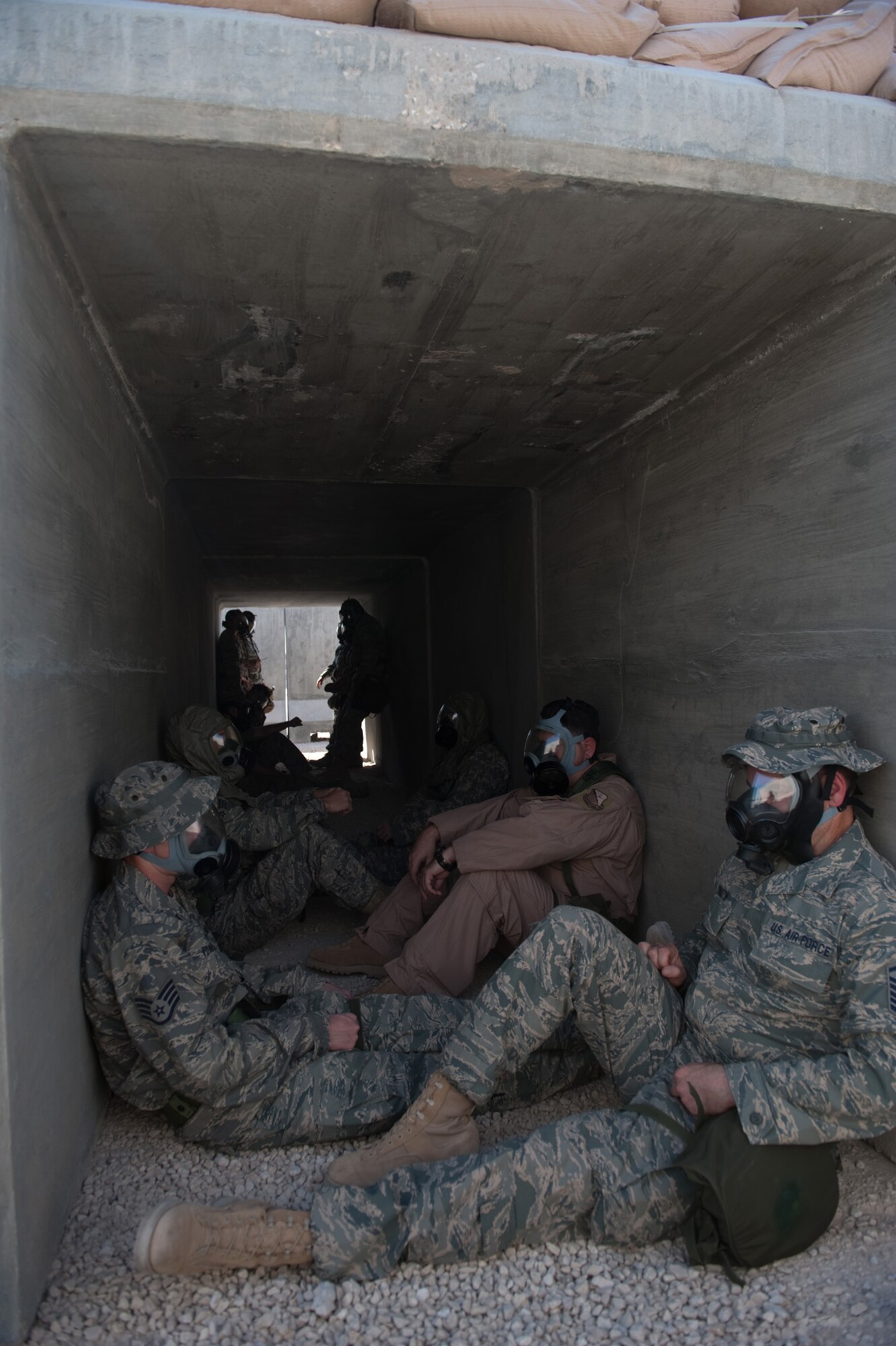 Airmen assemble in a bunker during a base defense exercise following a simulated attack, Nov. 3, 2009 in Southwest Asia. Personnel assigned to the 379th Air Expeditionary Wing and other tenant units participate in exercises regularly to train on a variety of potential real-world scenarios. (U.S. Air Force Photo/Staff Sgt. Robert Barney) 