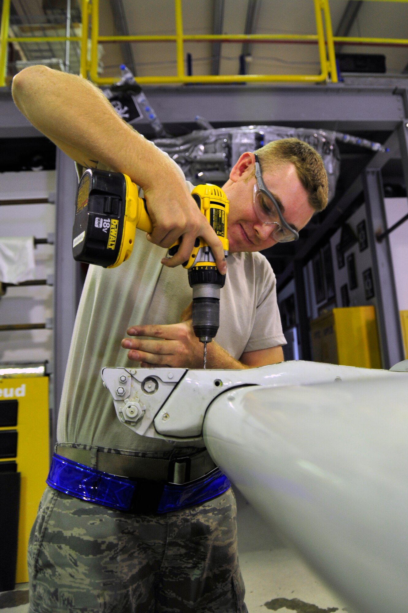SOUTHWEST ASIA -Airman 1st Class Jason Cunha, 380th Expeditionary Maintenance Squadron, drills-out a stripped screw from a flight control surface Nov. 3, 2009. Airman Sparks is currently deployed from Beale Air Force Base, Calif., and grew up in Lexington, Mass. (U.S. Air Force photo/Tech. Sgt. Charles Larkin Sr) 