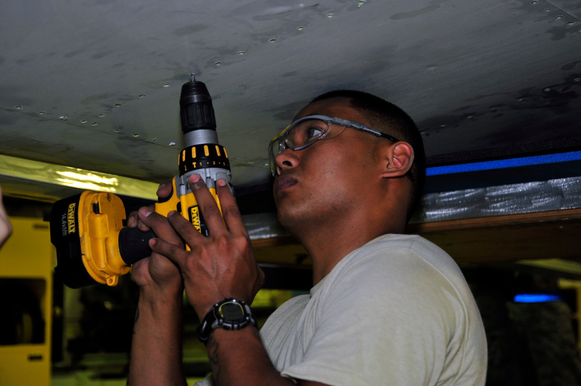 SOUTHWEST ASIA -Senior Airman Steven Villados, 380th Expeditionary Aircraft Maintenance Squadron, uses a drill to remove a screw from a flight control surface Nov. 3, 2009. Airman Villados is currently deployed from Tinker Air
Force Base, Okla., and grew up in Waipio, Hawaii. (U.S. Air Force photo/Tech. Sgt. Charles Larkin Sr)