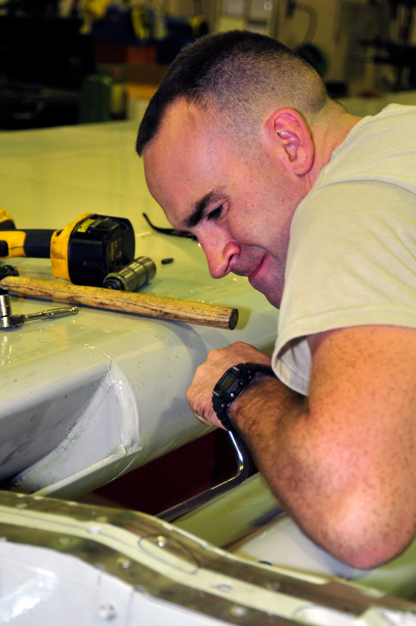 SOUTHWEST ASIA -Senior Airman Jason Sparks, 380th Expeditionary Aircraft Maintenance Squadron, uses a speed handle to remove a screw from a flight control surface Nov. 3, 2009. Airman Sparks is currently deployed from Tinker Air Force Base, Okla., and grew up in Houston, Texas. (U.S. Air Force photo/Tech. Sgt. Charles Larkin Sr)