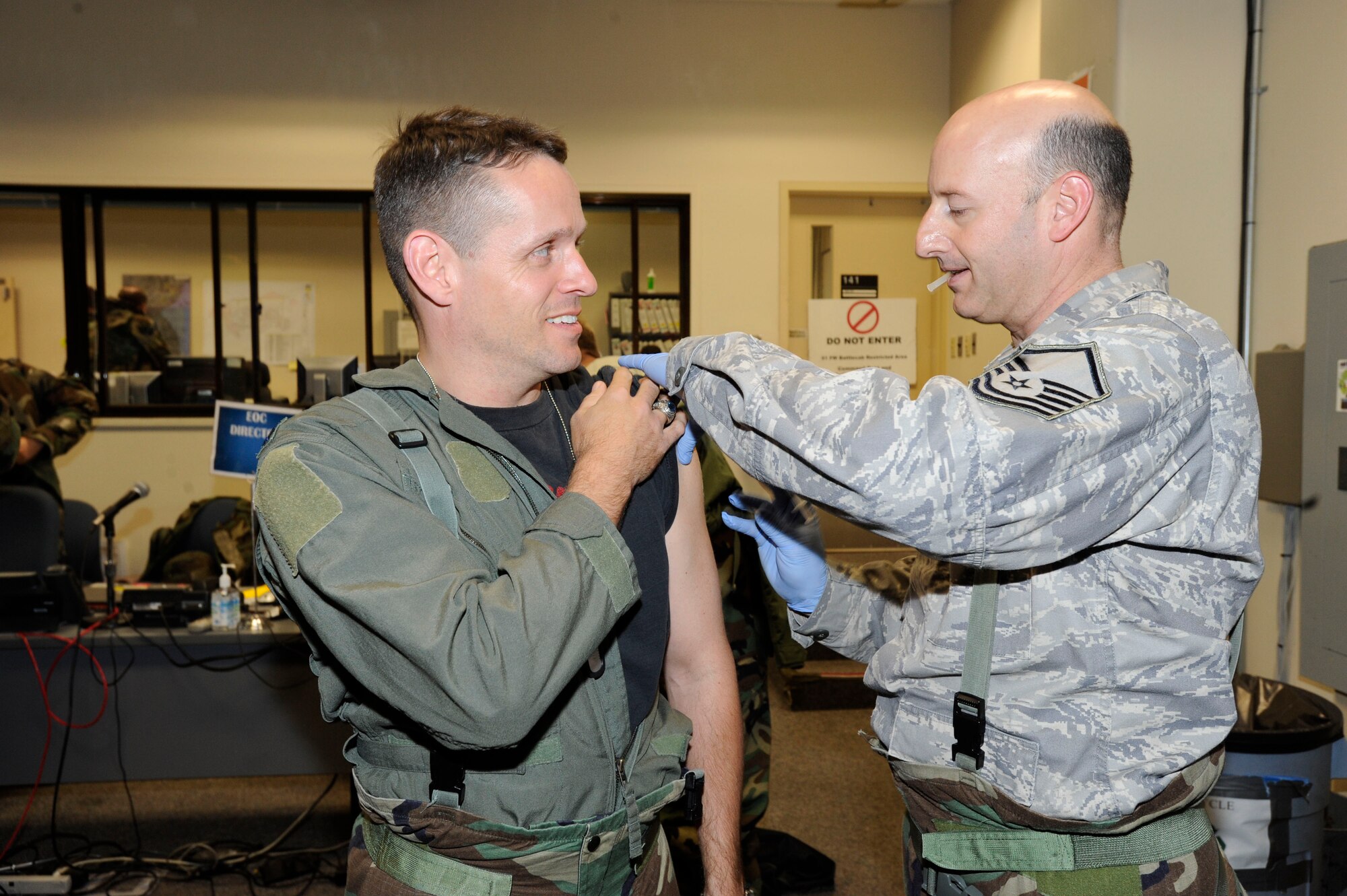 Lt. Col Scott Fisher receives the H1H1 Flu vaccination from Master Sgt. Mark Picchione Nov. 3 during the 51st Fighter Wing's Operational Readiness Exercise at Osan Air Base, Republic of Korea. The 51st MDG received H1N1 vaccinations for all military members stationed at Osan and base officials have said vaccinations for family members will arrive shortly. Colonel Fisher is the 51st Operations Support Squadron commander and Sergeant Picchioneis assigned to the 51st MDG. (U.S. Air Force photo/Senior Airman Stephenie Wade)   