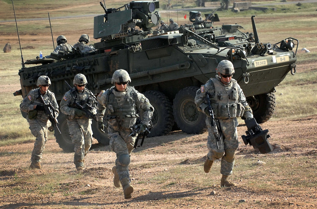 U.S. soldiers from the 2nd Squadron, 14th Cavalry Regiment exit their Stryker combat vehicle and head to a firing point to fire the ant-tank weapon, the Javelin Oct. 26, 2009, during a culminating joint exercise with the Indian army. The demonstration offered up both the conventional battlefield power of the Indian’s T-90 tanks with the high-technology precision of the U.S. military’s Javelin. 