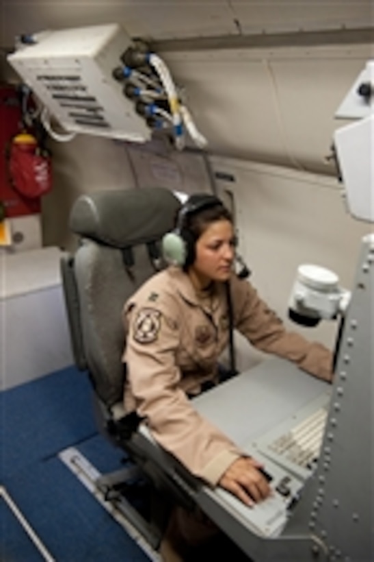 U.S. Air Force Capt. Dana Arrieta, a surveillance officer with the 7th Expeditionary Air Command and Control Squadron, manages the radar aboard an E-8 Joint Surveillance Target Attack Radar System (JSTARS) aircraft in Southwest Asia on Oct. 24, 2009.  The JSTARS is an airborne battle management, command and control, intelligence, surveillance and reconnaissance platform deployed in support of operations Iraqi and Enduring Freedom.  