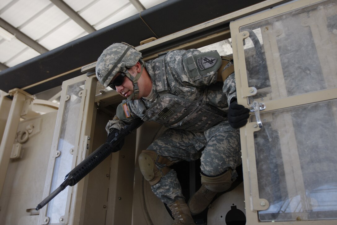 MARINE CORPS AIR GROUND COMBAT CENTER TWENTYNINE PALMS, Calif. - U. S. Army Staff Sgt. Michael Reyes, a civil affairs specialist with the 358th Civil Affairs Group, climbs out of a Mine Resistant Armor Protected Egress Trainer vehicle simulator at the Combat Center's Battle Simulation Center Nov. 6.