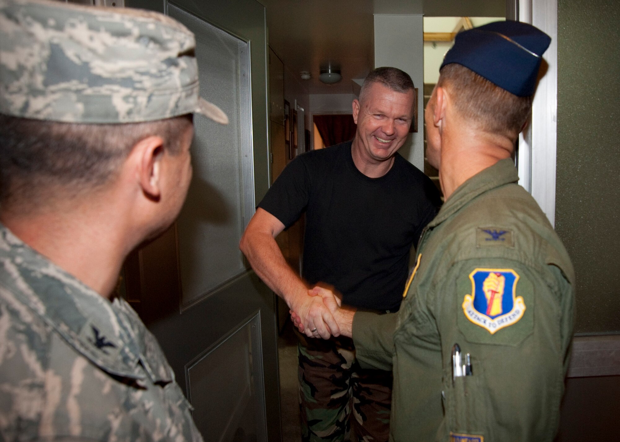 MISAWA AIR BASE, Japan -- R.C. Craig, 35th Fighter Wing vice commander, congratulates Senior Master Sgt. William Wilkinson Jr., 35th Maintenance Squadron munitions flight superintendent, on his selection for promotion to chief master sergeant at Sergeant Wilkinson's home Nov. 5. Seven senior master sergeants were selected from Misawa Air Base to include Senior Master Sgts. Wayne Cardwell, Rafael Charris, Barbara Krick, Paul Leubkert, John Mazza and Arlene Murray. Sergeant Wilkinson hails from Miami, Fla. (U.S. Air Force photo/Staff Sgt. Samuel Morse)