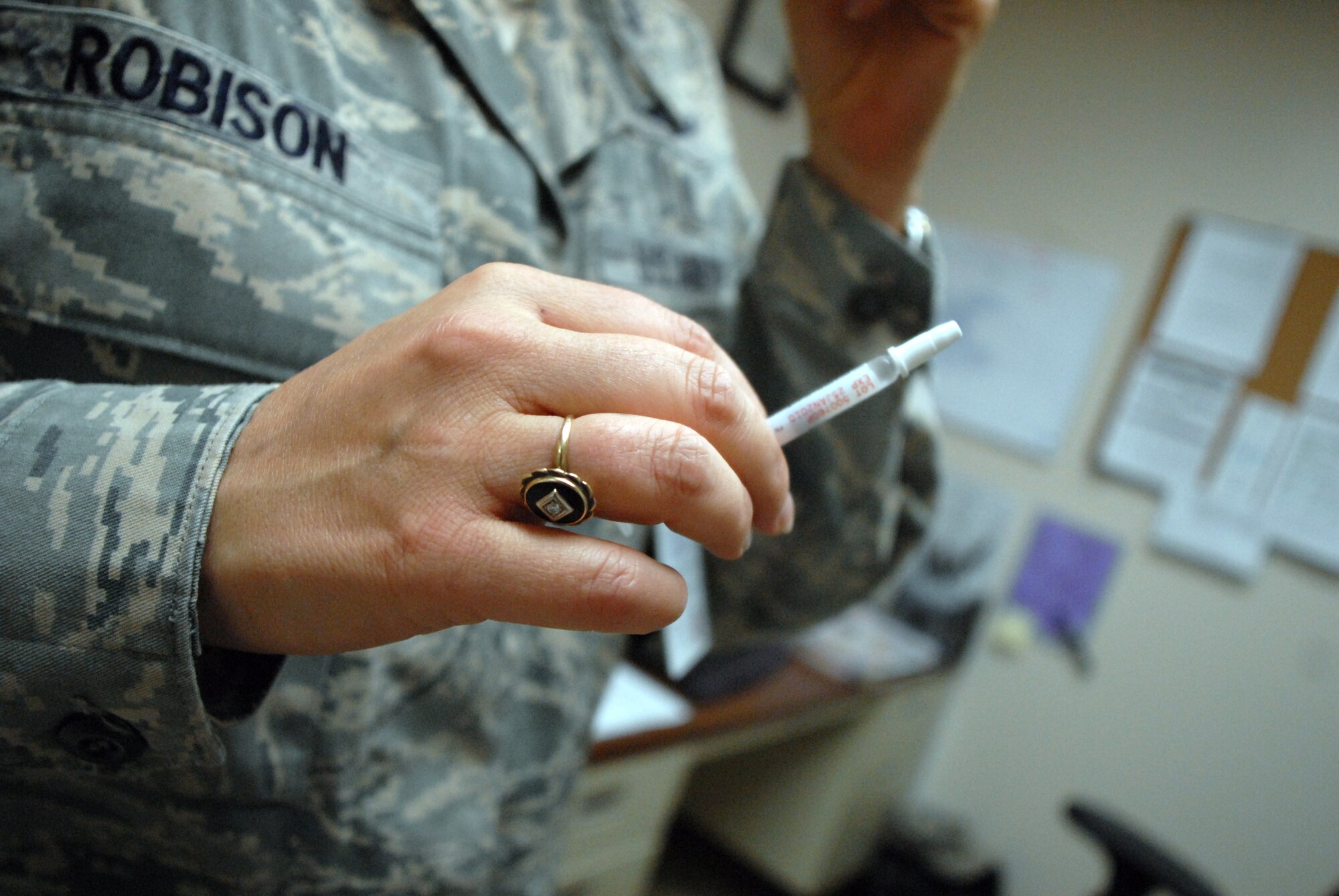 HICKAM AIR FORCE BASE, Hawaii -- Lt. Colonel Cindy Robison, 15th Medical Group, explains the difference in the H1N1 flu shot and the flumist before vaccinating Capt. Samantha Kelpis, 15th Medical Group, here Nov. 5. The medical group currently does not have injectable H1N1 influenza vaccine in stock. Individuals receiving the vaccination cannot have chronic diseases such as asthma, angina, cancer, kidney disease, lung disease, diabetes, heart disease, or, history of a heart attack or stroke. In addition, the medical group does not have the vaccine available for pregnant individuals or those having used steroids or cortisone in last three months. (U.S. Air Force photo/Senior Airman Gustavo Gonzalez)