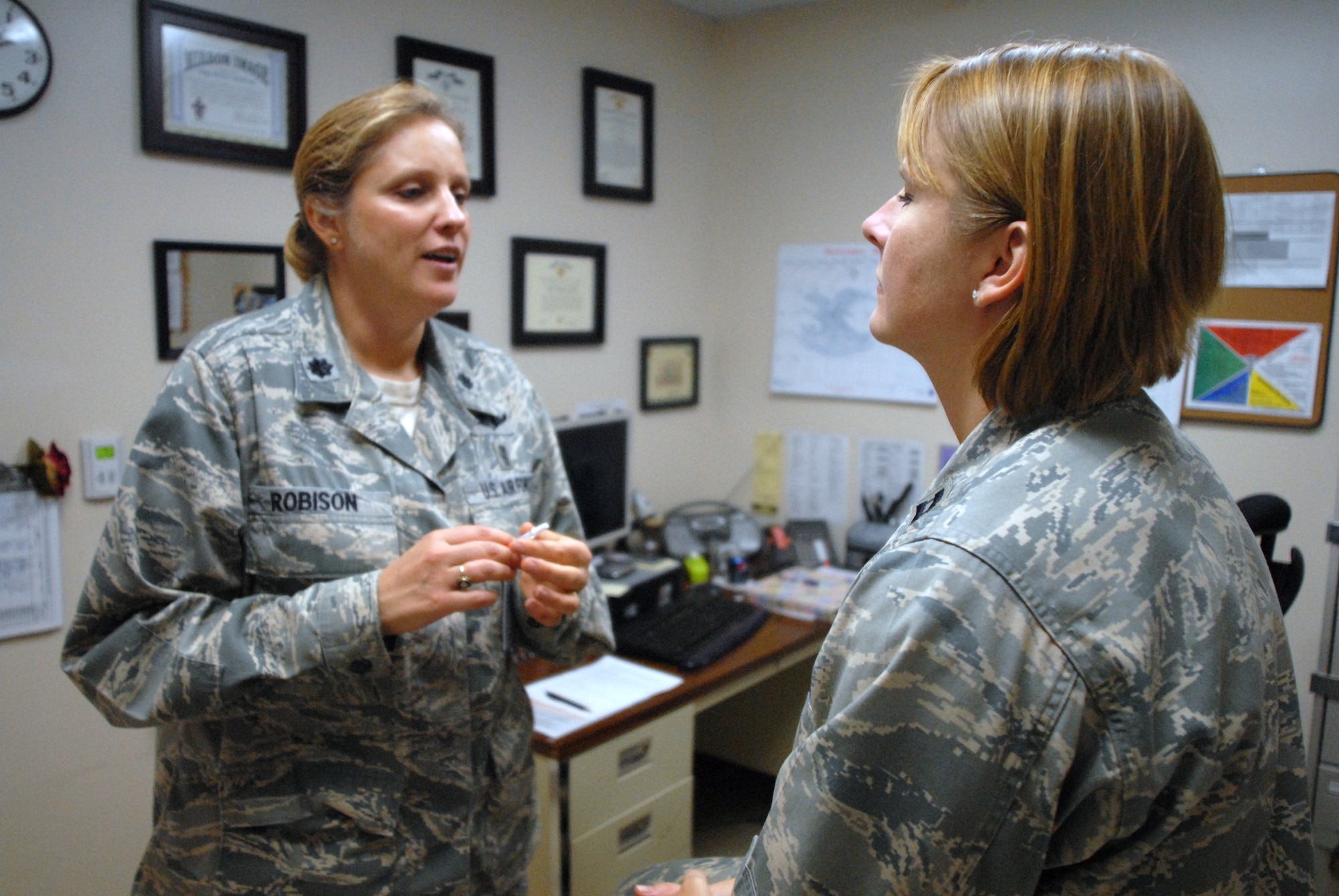 HICKAM AIR FORCE BASE, Hawaii -- Lt. Col. Cindy Robison, 15th Medical Group, explains the difference in the H1N1 flu shot and the flumist before vaccinating Capt. Samantha Kelpis, 15th Medical Group, here Nov. 5. The clinic is receiving small batches of injectable H1N1 vaccine on a weekly basis and will continue to provide updates as the vaccine comes available. To receive a shot, eligible individuals should walk into the Immunizations Clinic during the following hours: Mondays and Fridays from 8 until 11:30 a.m. and 1 through 4 p.m. On Wednesdays from from 8 until 11:30 a.m. and 1 through 2 p.m. Tuesdays and Thursdays the clinics hours of operations are from 7:30 until 11:30 a.m. and 1 through 4 p.m. The clinic is closed the third Thursday of the month after 11:30 a.m. For more information, call Staff Sgt. Jill Bass at 448-6275. (U.S. Air Force photo/Senior Airman Gustavo A.S. Gonzalez)