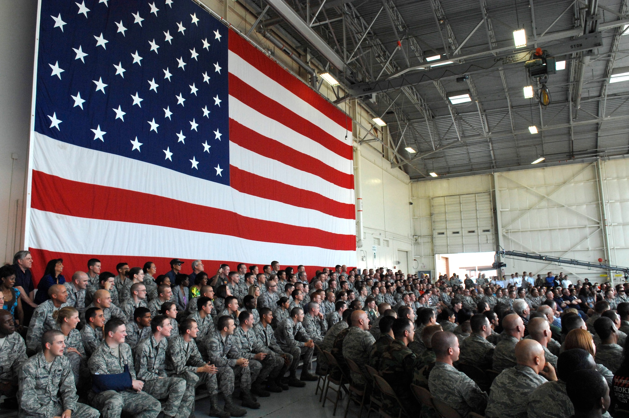 Luke Air Force Base Airmen and their families watch the filming of comedian Frank Caliendo's segment for the FOX NFL pregame show in Hanger 999 at the 944th Fighter Wing at Luke AFB, Ariz., Nov. 4, 2009. (U.S. Air Force photo by Staff Sgt. Gary Mathieson)