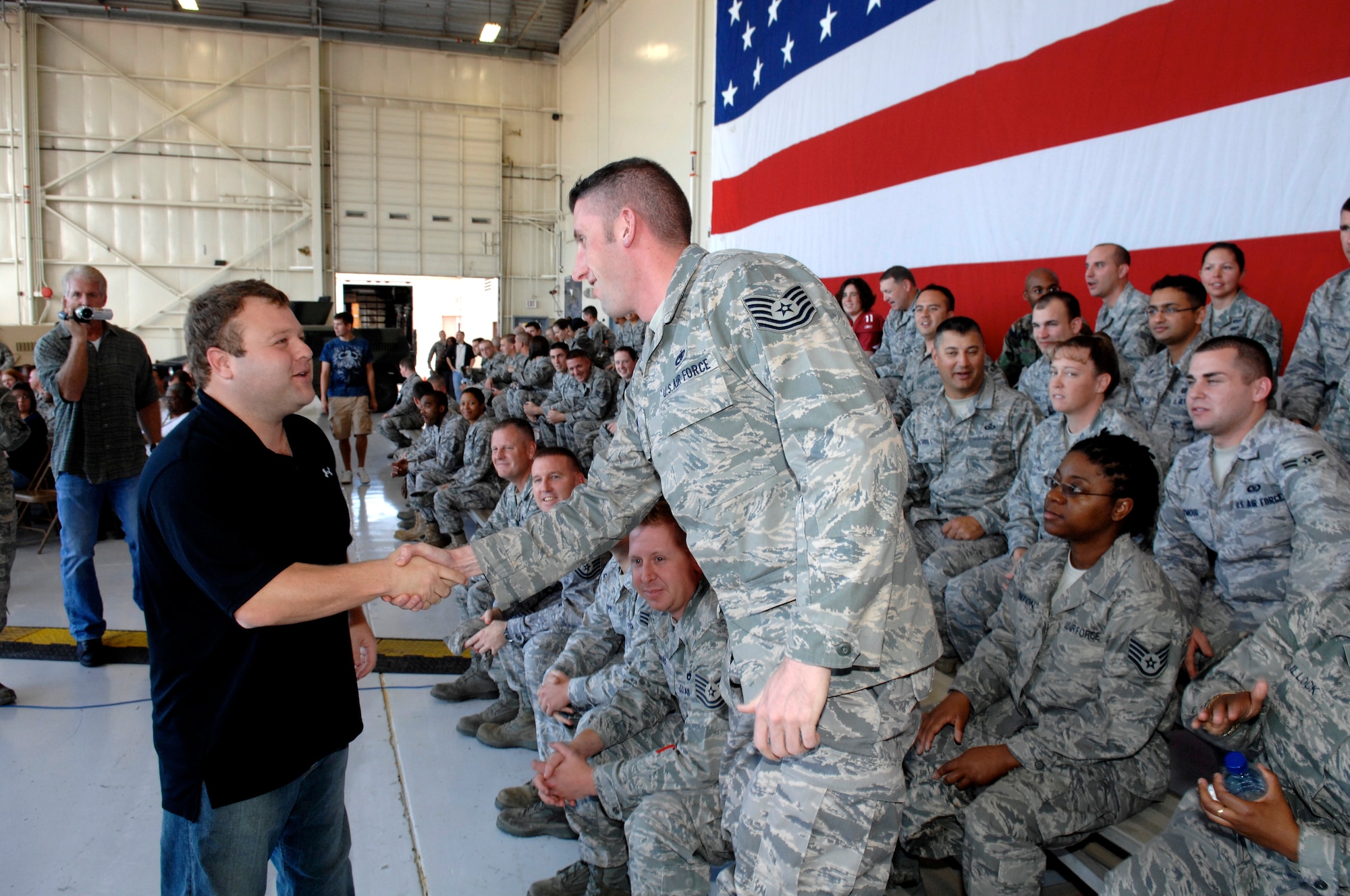 Comedian and impressionist Frank Caliendo takes a moment to greet military members in the audience before he tapes his FOX NFL pregame show segment at Luke Air Force Base, Ariz. (U.S. Air Force photo by Staff Sgt. Gary Mathieson)