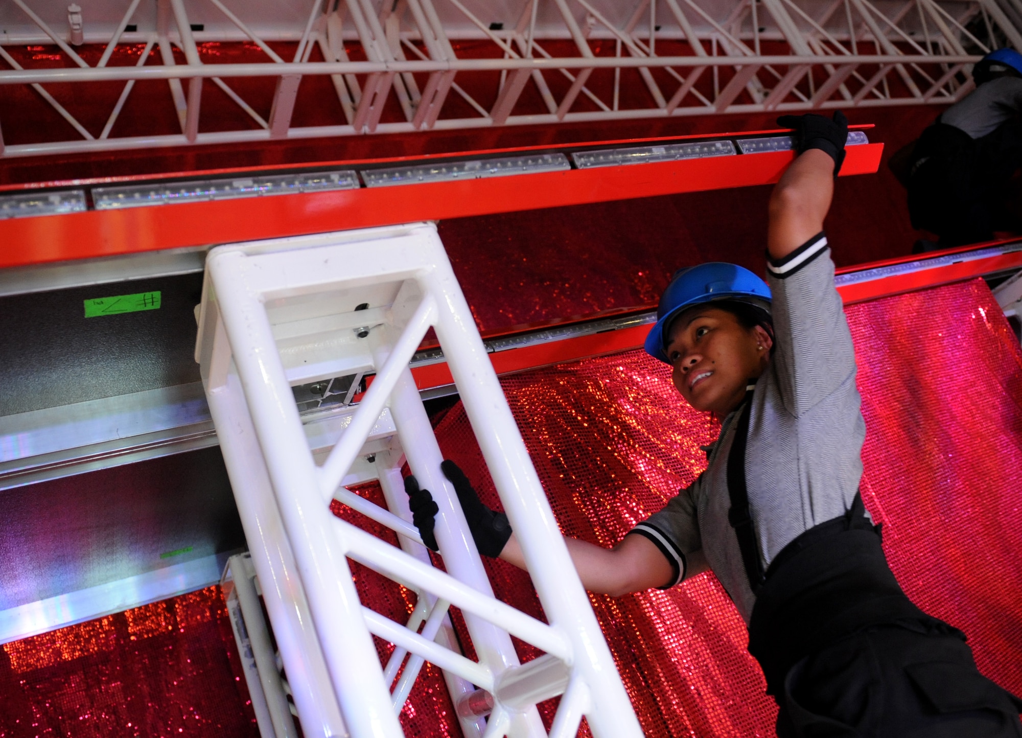 VALDOSTA, Ga. -- Senior Airman Jennifer Bone, Tops in Blue vocalist, helps build the stage before a performance at the Mathis Auditorium here Nov. 4. Building the stage can take anywhere from two to four hours. (U.S. Air Force photo by Senior Airman Gina Chiaverotti-Paige)  