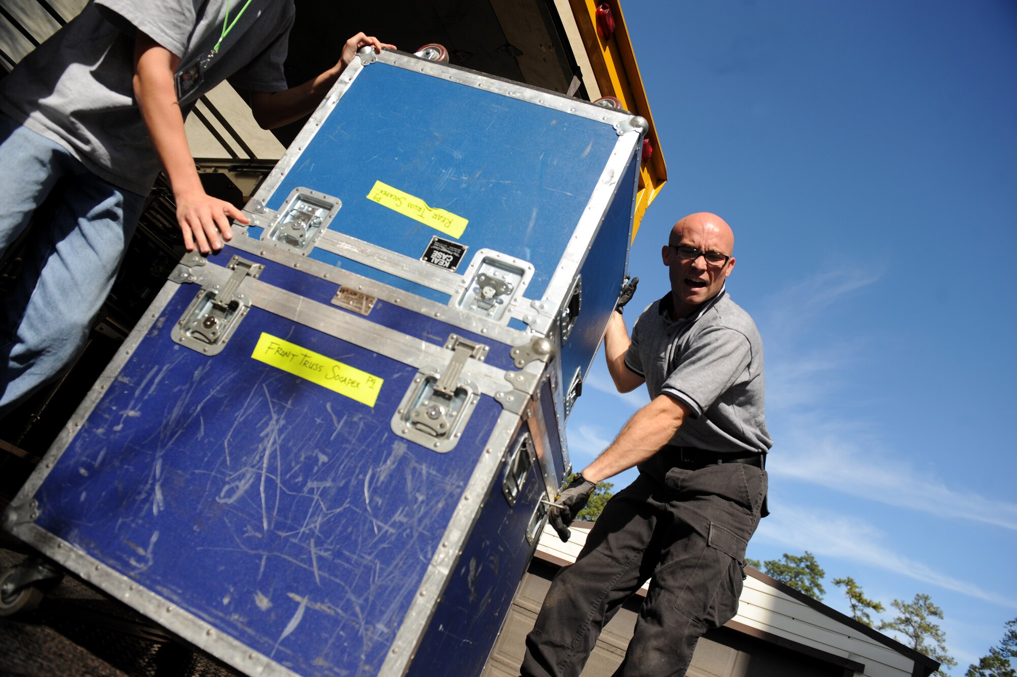 VALDOSTA, Ga. -- Senior Airman Jeffrey Collins, Tops in Blue vocalist, calls for more volunteers to help unload equipment at the Mathis Auditorium here Nov. 4. Volunteers from Moody Air Force Base helped the Tops in Blue team set up equipment after their truck broke down in Florida. (U.S. Air Force photo by Senior Airman Gina Chiaverotti-Paige)
