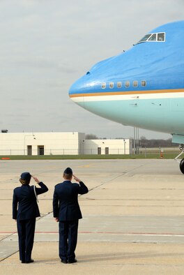 An unnamed Air Force lieutenant colonel, who serves as the military aide to the president, and Col. Joe Brandemuehl, commander of the 115th Fighter Wing, Wisconsin Air National Guard, render salutes as Air Force One taxis to a stop at the air base Nov. 4. President Barack Obama arrived at the fighter wing en route to visiting Madison's Wright Middle School. (Wisconsin National Guard photo by Sgt. 1st Class Vaughn R. Larson)