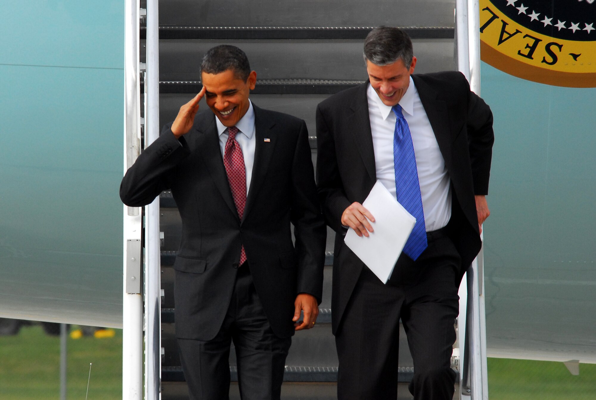 President Barack Obama (left) salutes as he descends down the stairs out of Air Force One with Secretary of Education, Arne Duncan at the 115th Fighter Wing in Madison Wis., Nov. 4, 2009.  The President visited the Air National Guard base on his way to give a speech at Madison’s James Wright middle school about education reform.  President Obama's visit marks the first time that a sitting president has visited the base. (U.S. Air Force Photo by Master Sgt. Dan Richardson)