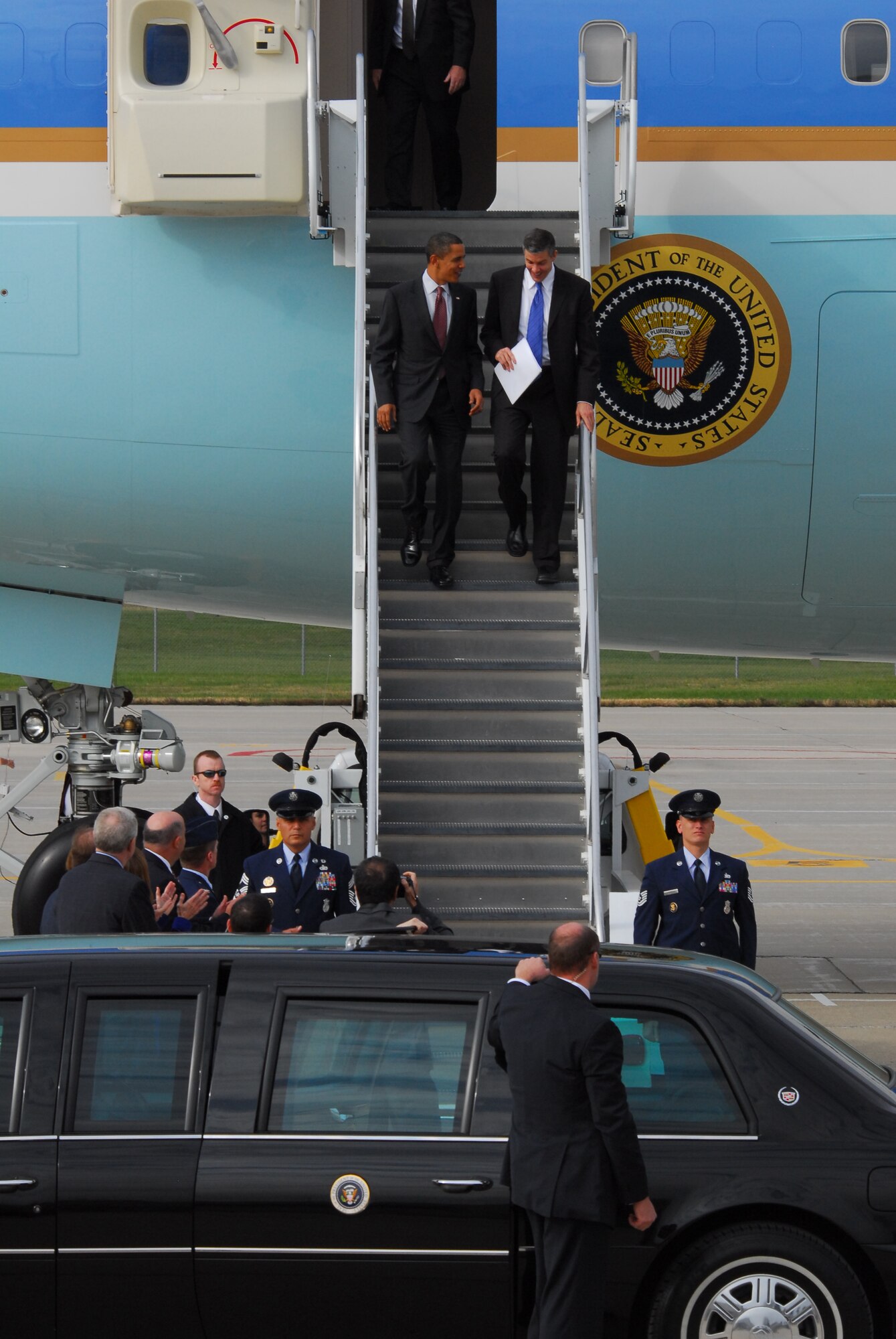 President Barack Obama (left) descends down the stairs out of Air Force One with Secretary of Education, Arne Duncan at the 115th Fighter Wing in Madison Wis., Nov. 4, 2009.  The President visited the Air National Guard base on his way to give a speech at Madison’s James Wright middle school about education reform.  President Obama's visit marks the first time that a sitting president has visited the base. (U.S. Air Force Photo by Master Sgt. Dan Richardson)