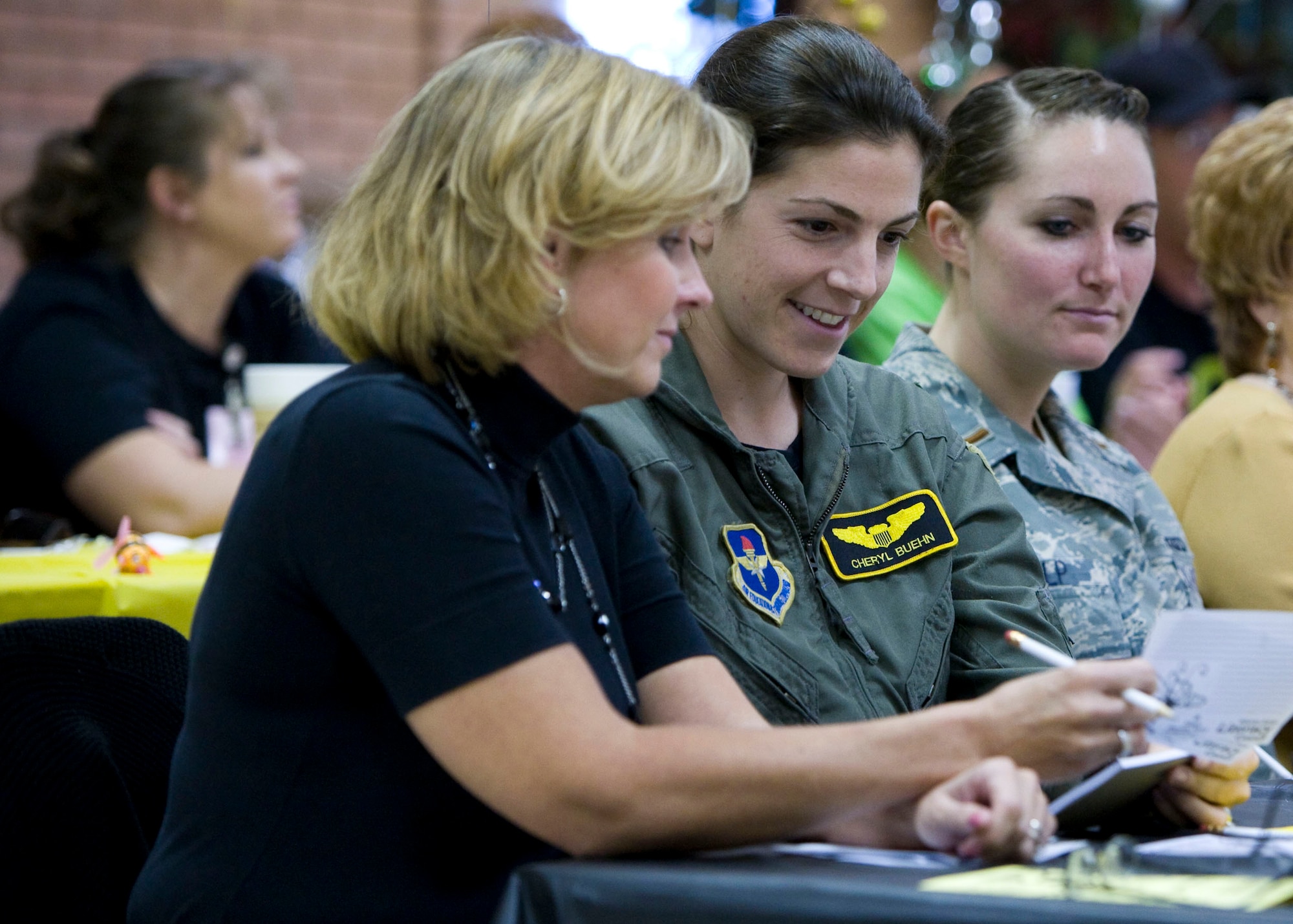 From left to right, Michele Houck, Capt. Cheryl Buehn and 2nd Lt. Christina Kulp, all from the 80th Flying Training Wing, compete in the 13th Annual Wichita Falls Adult Literacy Council Spelling Bee Nov. 4 at the Women's Forum in Wichita Falls, Texas. The team was one of 19 in competition, and they made it to the sixth round. (U.S. Air Force photo/Lt. Col. Ternell Washington)