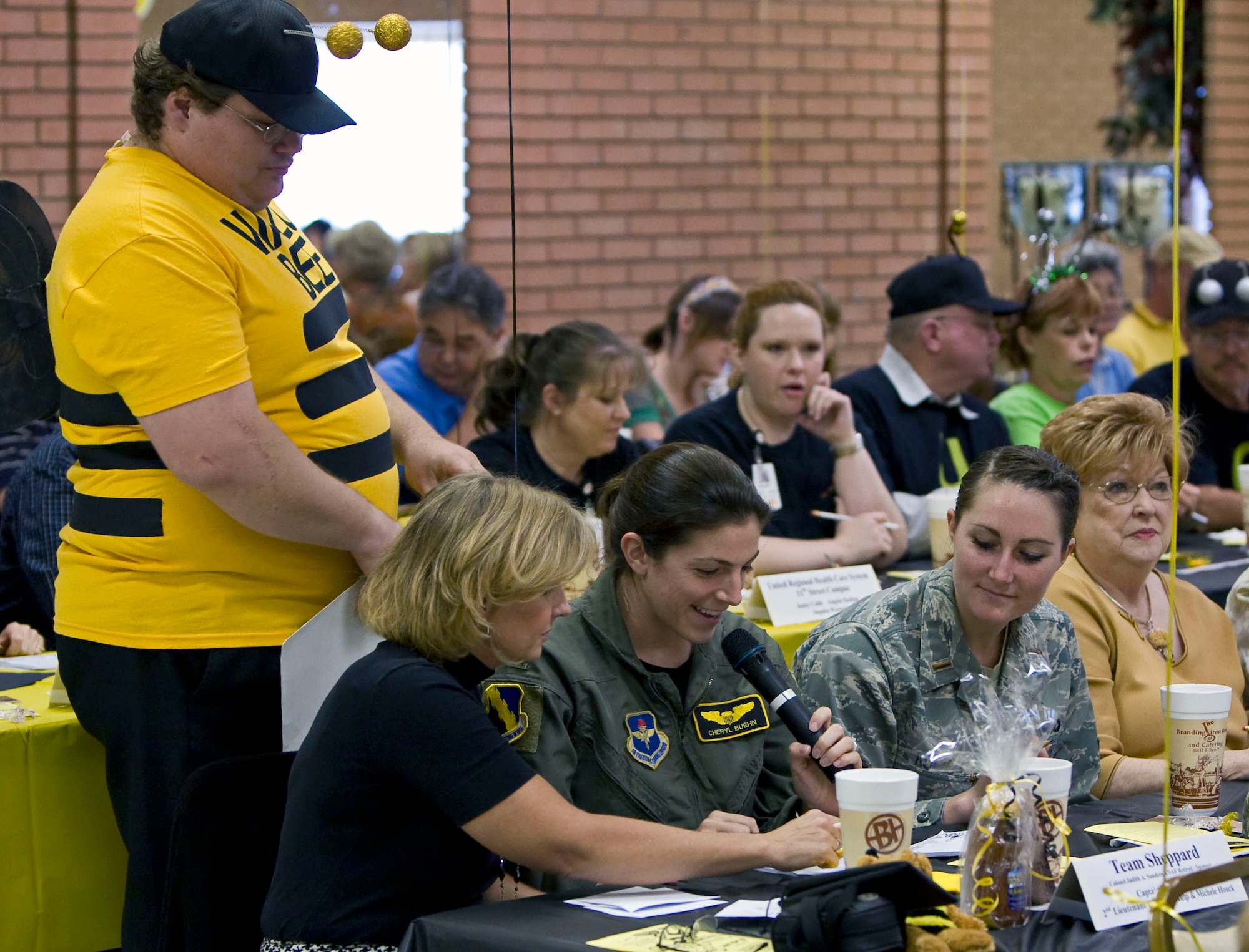 Capt. Cheryl Buehn, center, from the 80th Flying Training Wing, spells out a word Nov. 4 during the 13th Annual Wichita Falls Adult Literary Council Spelling Bee at the Women's Forum in Wichita Falls, Texas. The team of Captain Buehn, Michele Houck, left, and 2nd Lt. Christina Kulp made it to the sixth round of competition. (U.S. Air Force photo/Lt. Col. Ternell Washington)