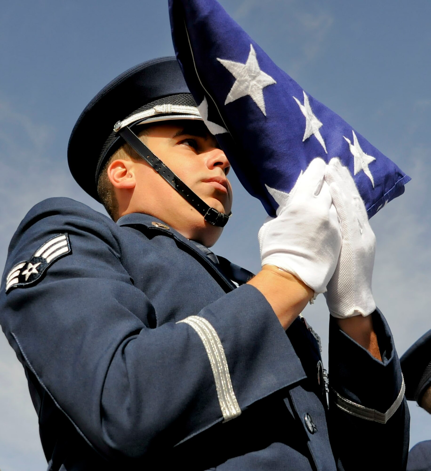 CANNON AIR FORCE BASE, N.M. --  Senior Airman William McCabe, 27th Special Operations Communications Squadron, dresses the flag in preparation to present it to the next of kin during training here, Oct. 28. After the gun salute is performed by the guardsmen, the noncommissioned officer in charge of pall bearing presents the flag to the next of kin reciting, "Sir/Ma'am, on behalf of the President of the United States, Department of the Air Force and our grateful nation, I offer you this flag in memory of your loved one's service." (U.S. Air Force photo/ Senior Airman Erik Cardenas)