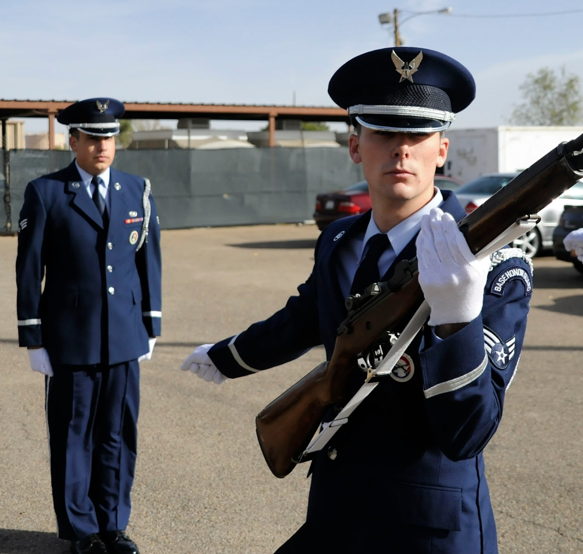 CANNON AIR FORCE BASE, N.M. -- Senior Airman Mark King, 27th Special Operations Equipment Maintenance Squadron, fires off one of three rounds as Senior Airman William McCabe, 27th Special Operations Communications Squadron, gives commands here during training here, Oct. 28. The base honor guard covers 62,000 square miles of Eastern New Mexico and West Texas. (U.S. Air Force photo/ Senior Airman Erik Cardenas)