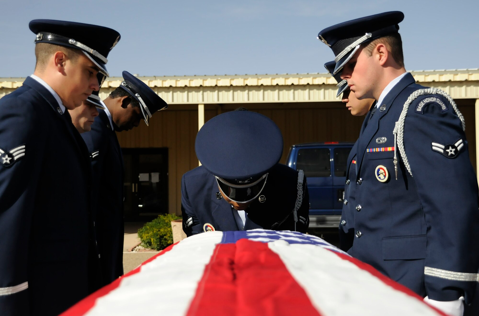 CANNON AIR FORCE BASE, N.M. -- Airmen from the base honor guard prepare to pull the casket out in a mock funeral ceremony here, Oct. 28. The ceremony includes seven guardsmen; six carry the casket and one  calls the commands to the firing party. The training is vital as Airmen give their final respects the person who served in the military. (U.S. Air Force photo/ Senior Airman Erik Cardenas)