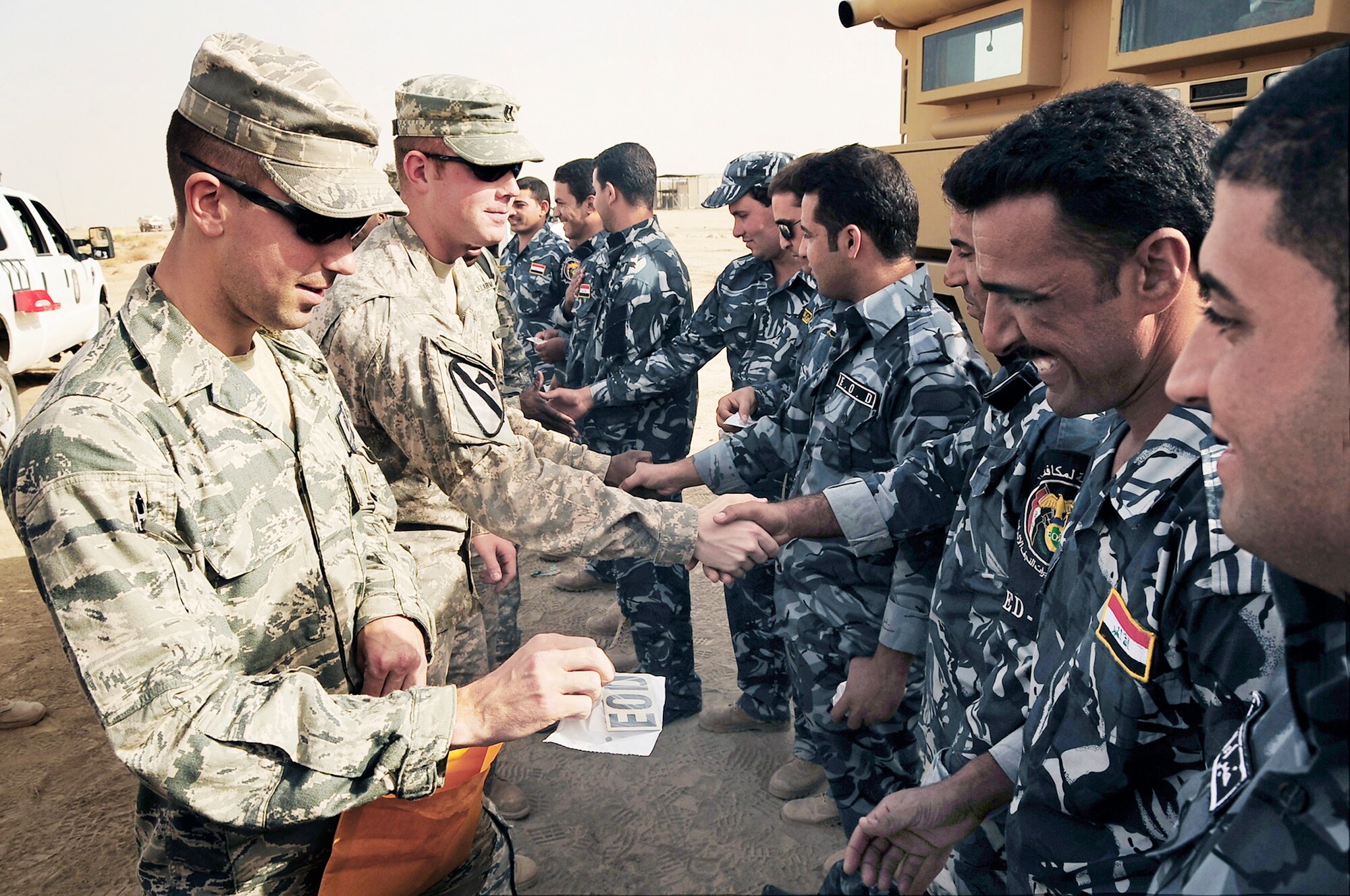 Staff Sgt. Jonathan Quast gives Iraqi police explosive ordnance disposal technicians their EOD patches upon completion of several hours of training conducted by Air Force EOD members Nov. 4, 2009, at Forward Operating Base Cedar, Iraq. Sergeant Quast is a 407th Expeditionary Civil Engineer Squadron EOD technician deployed from MacDill Air Force Base, Fla. (U.S. Air Force photo/Senior Airman Tony R. Ritter) 