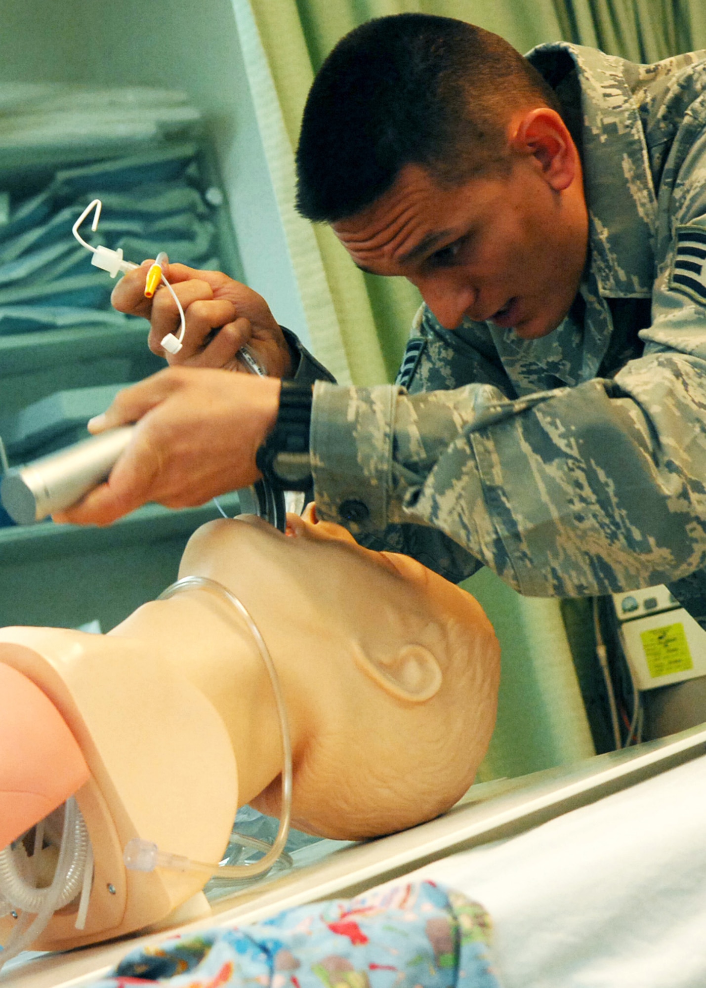 JOINT BASE BALAD, Iraq -- Staff Sgt. Christopher Hipsher, 332nd Expeditionary Communications Squadron small computer technician, practices endotracheal intubation techniques on a training dummy at the Air Force Theater Hospital here Oct. 22, 2009. Sergeant Hipsher is an emergency medical technician volunteer and is state certified in Hawaii. (U.S. Air Force photo/ Senior Airman Christopher Hubenthal)