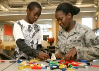 Tech. Sgt. Drita Borel and her son Adrian play with Legos during the Lackland Youth Center open house Nov. 4. The open house was part of Air Force Family Week which recognized and celebrated the Air Force family while providing education and awareness about base and community support programs. Sergeant Borel is with the 59th Diagnostics and Therapeutics Squadron. (U.S. Air Force photo/Robbin Cresswell)
