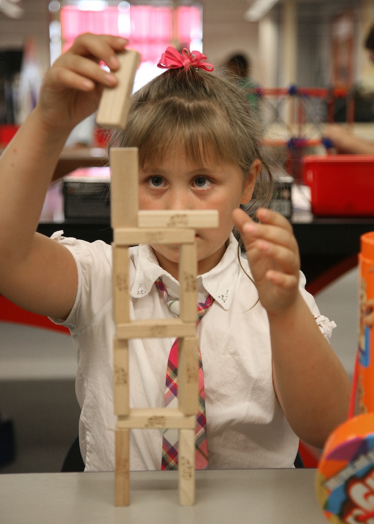 Aidan Sanders carefully stacks Jenga blocks during the Lackland Youth Center open house Nov. 4. The open house was part of Air Force Family Week which recognized and celebrated the Air Force family while providing education and awareness about base and community support programs. Aidan is the daughter of Capt. Tina Sanders, 711th Human Performance Wing at Brooks City-Base. (U.S. Air Force photo/Robbin Cresswell)