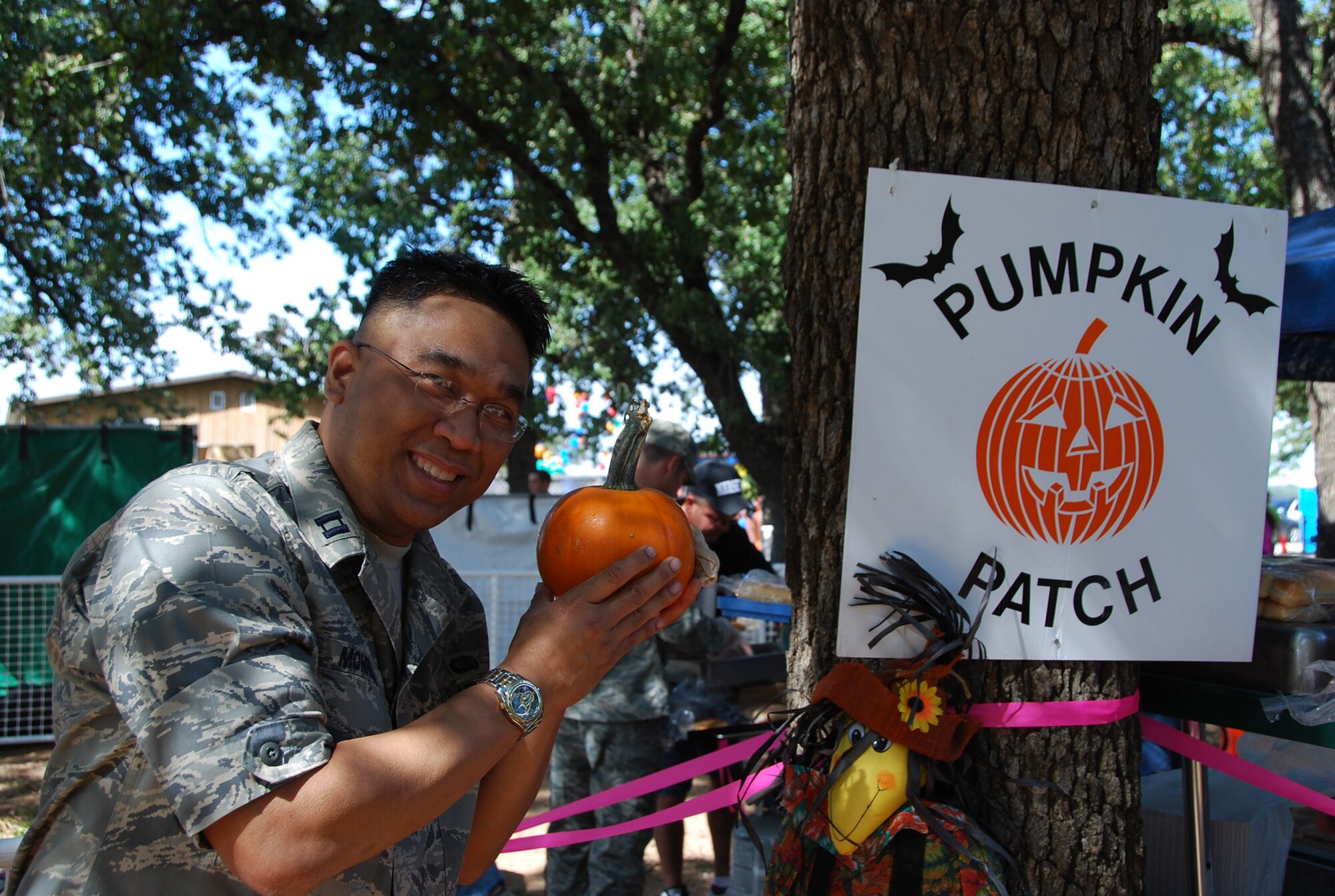 Captain Marc Monreal, 301st Mission Support Group executive officer, minded the pumpkin patch so kids could choose a free pumpkin Saturday during October's wing picnic. (U.S. Air Force photo/TSgt Shawn David McCowan)