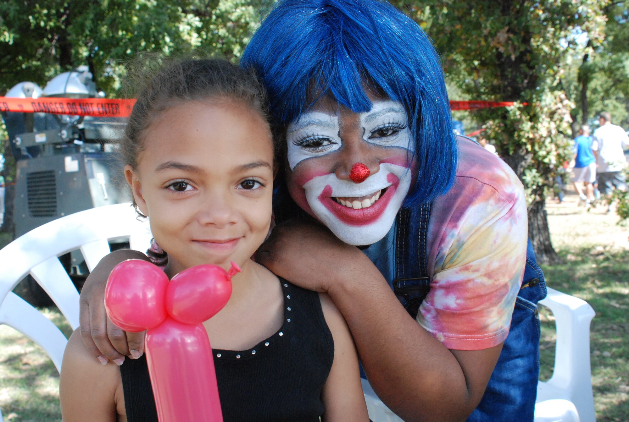 SrA Annika Regala, member of 301st Communications Flight, and Megan Bailey,
daughter of TSgt Stephen Bailey, 301st PA, enjoy some ‘clowning’ with balloons recently during October's annual wing family day picnic. (U.S. Air Force Photo/TSgt Stephen C. Bailey)