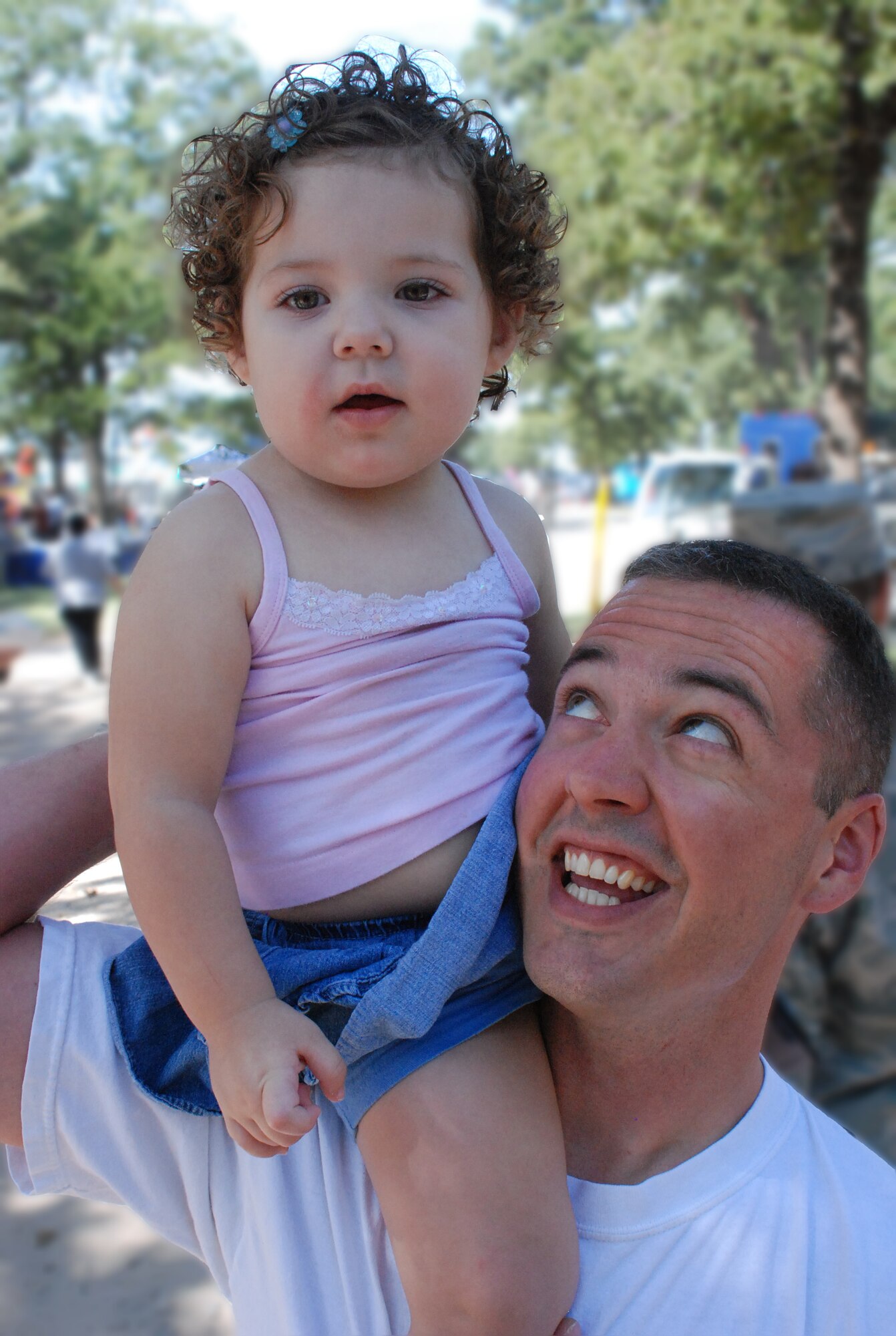 TSgt Christopher Newark, a member of 301st Fighter Wing, admires his 18-month-old daughter on top of his shoulder during the annual wing family day picnic.
(U.S. Air Force Photo/TSgt Stephen C. Bailey)